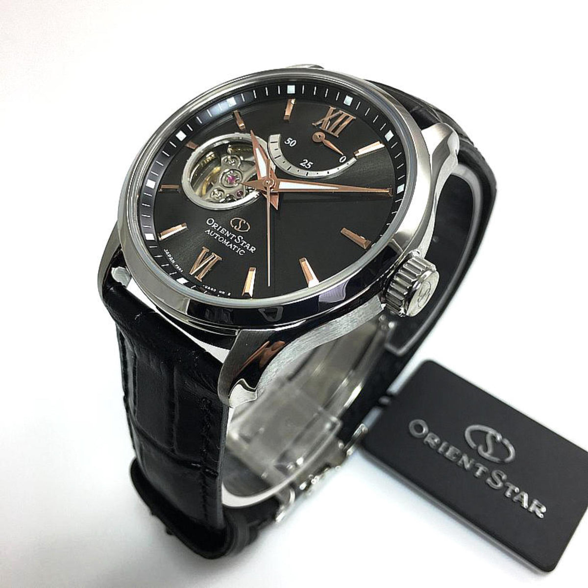 Automatic wrist watch angled view with black leather strap, silver case, dark dial