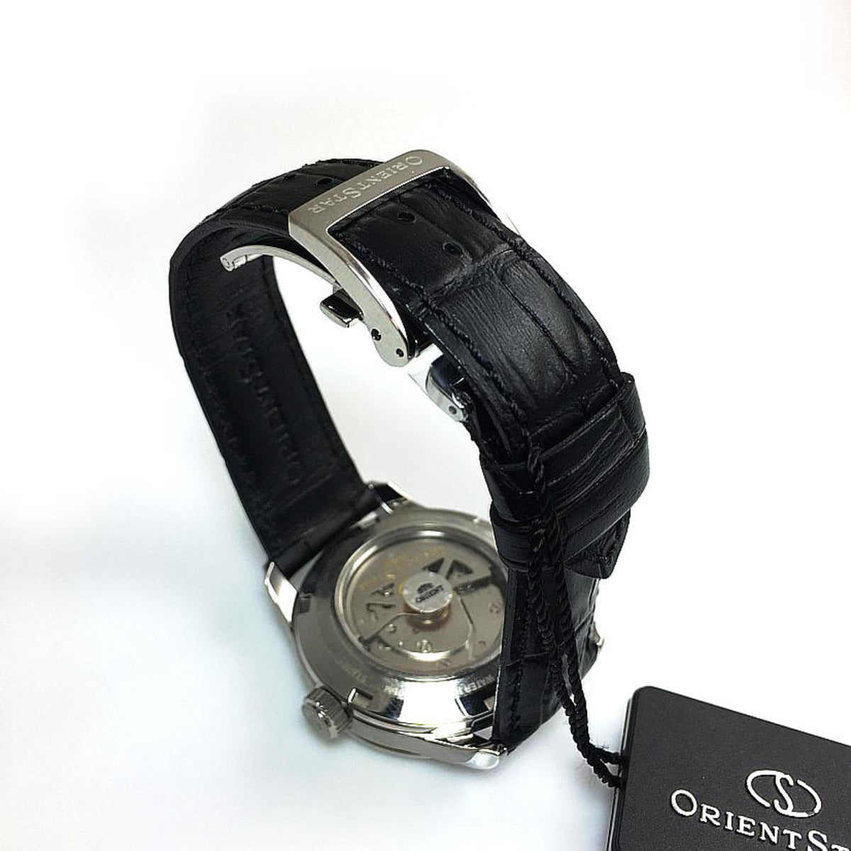 Automatic watch caseback view with black leather strap, silver case, exposed movement