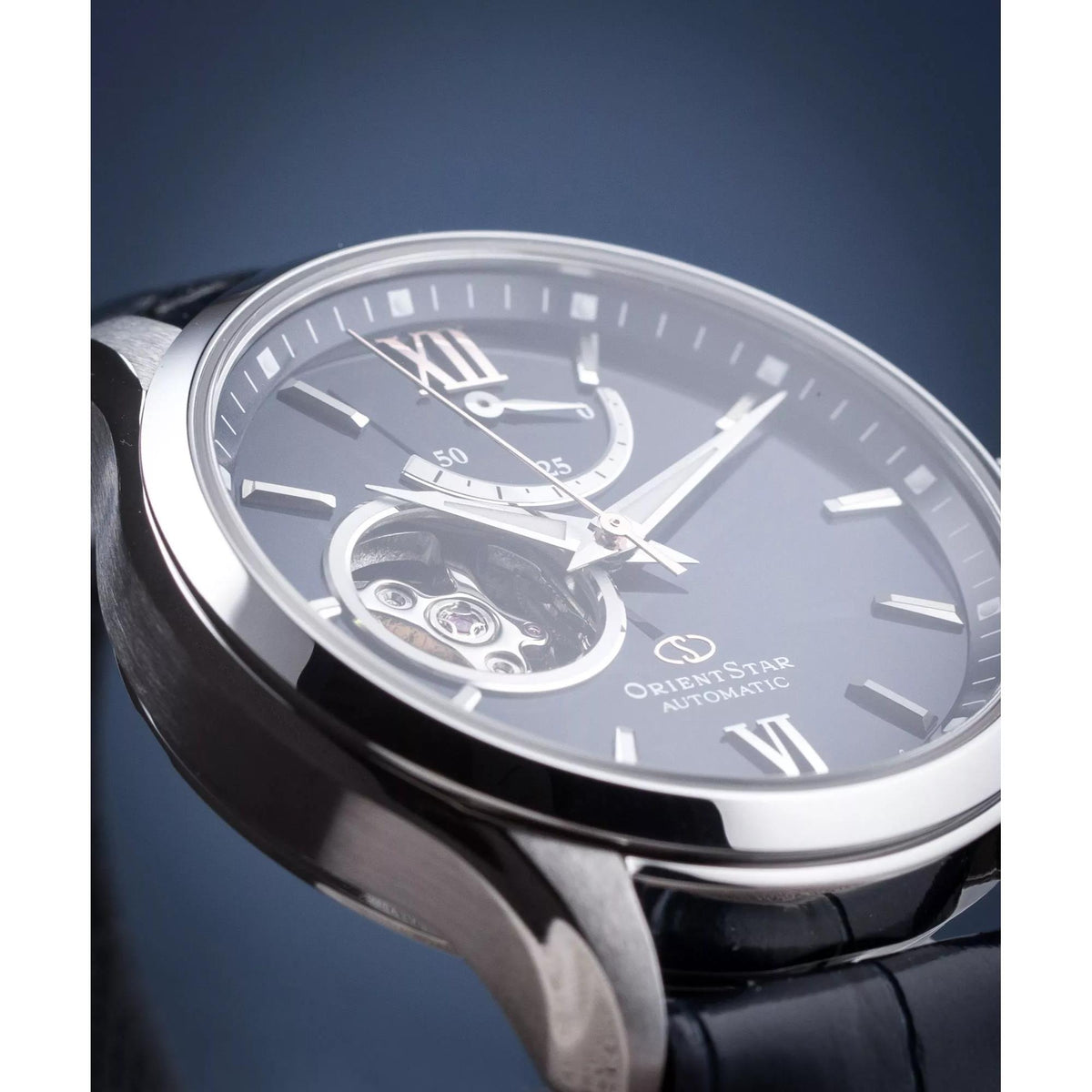 Semi-skeleton watch face with Roman numerals and visible movement