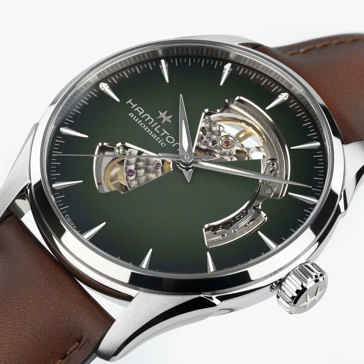 Close-up of a Hamilton Jazzmaster Open Heart watch with a green dial and brown leather strap.