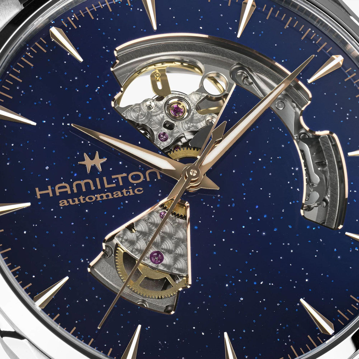 Hamilton Jazzmaster H32705640 mens watch dial close-up highlighting skeleton cutouts revealing gold tone internal movement components