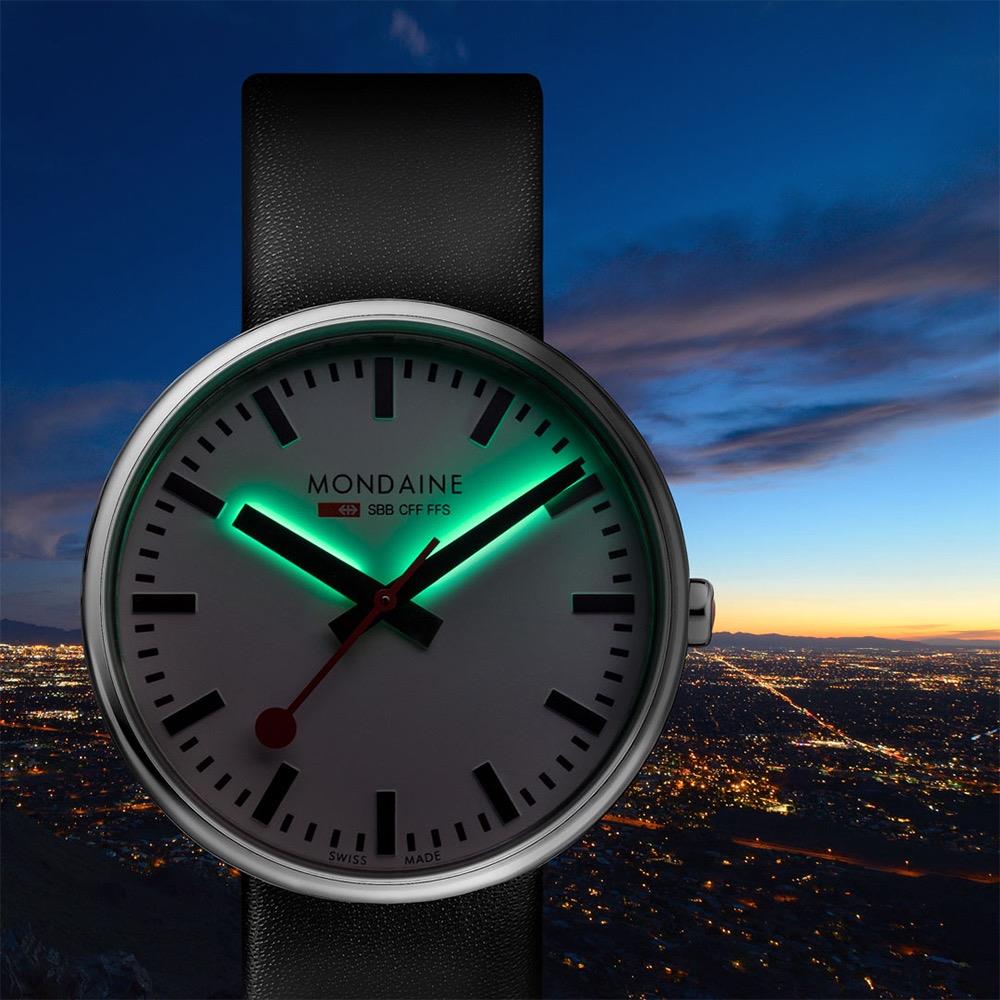 Mondaine mini quartz watch with green-tinted dial, black leather strap, silver case