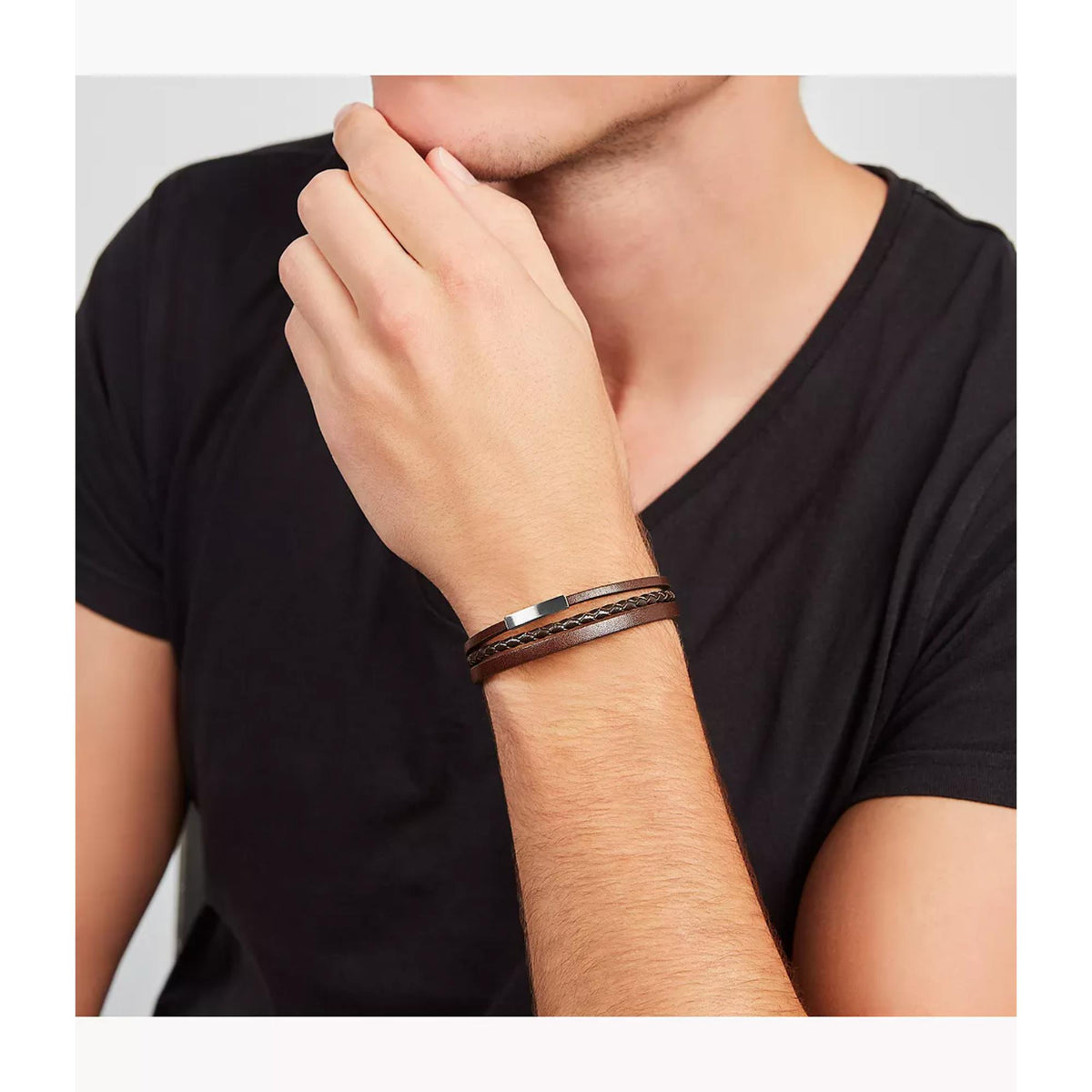 Brown leather multi-strand bracelet on a man’s wrist with silver clasp