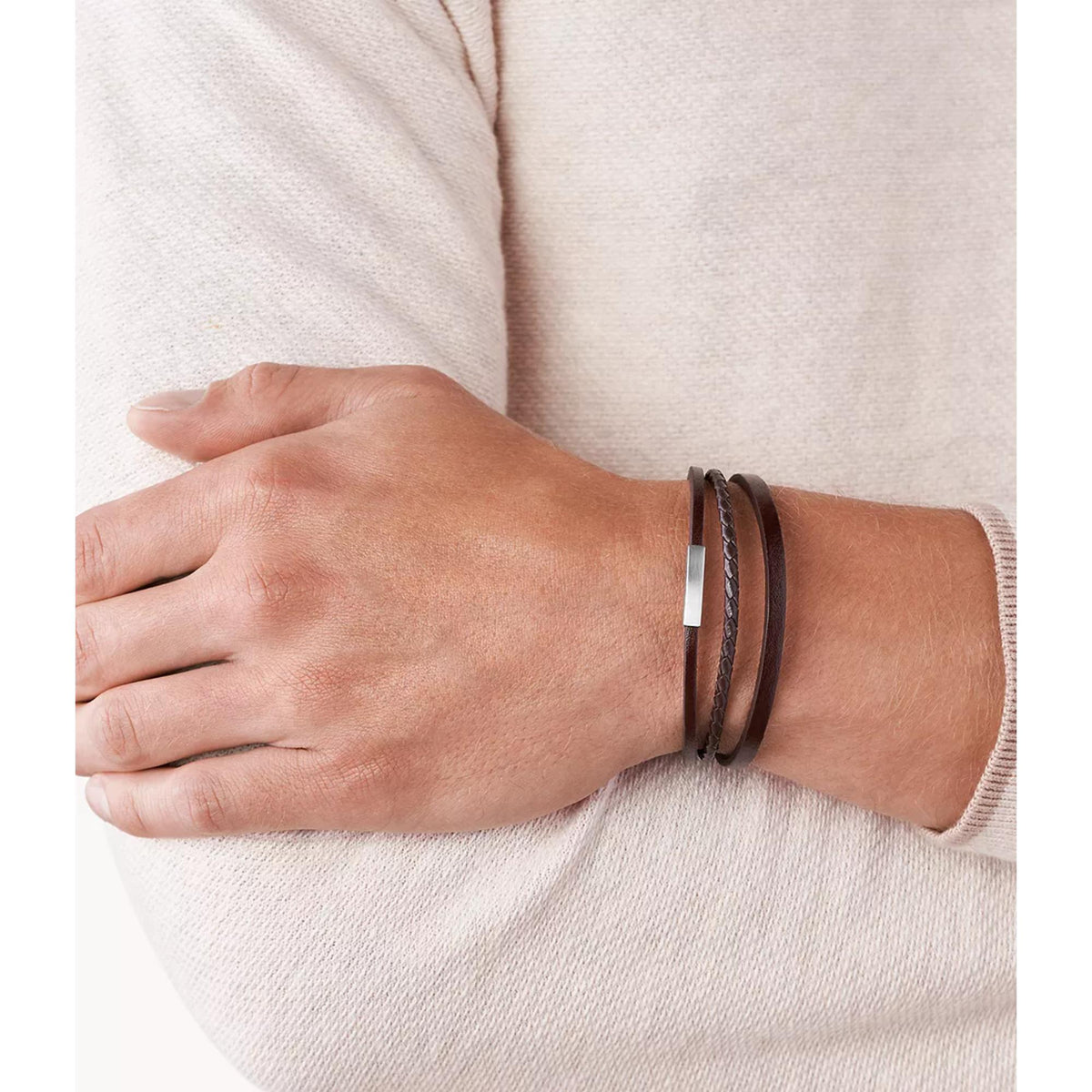 Brown leather bracelet with double wrap strands and silver-tone clasp on wrist