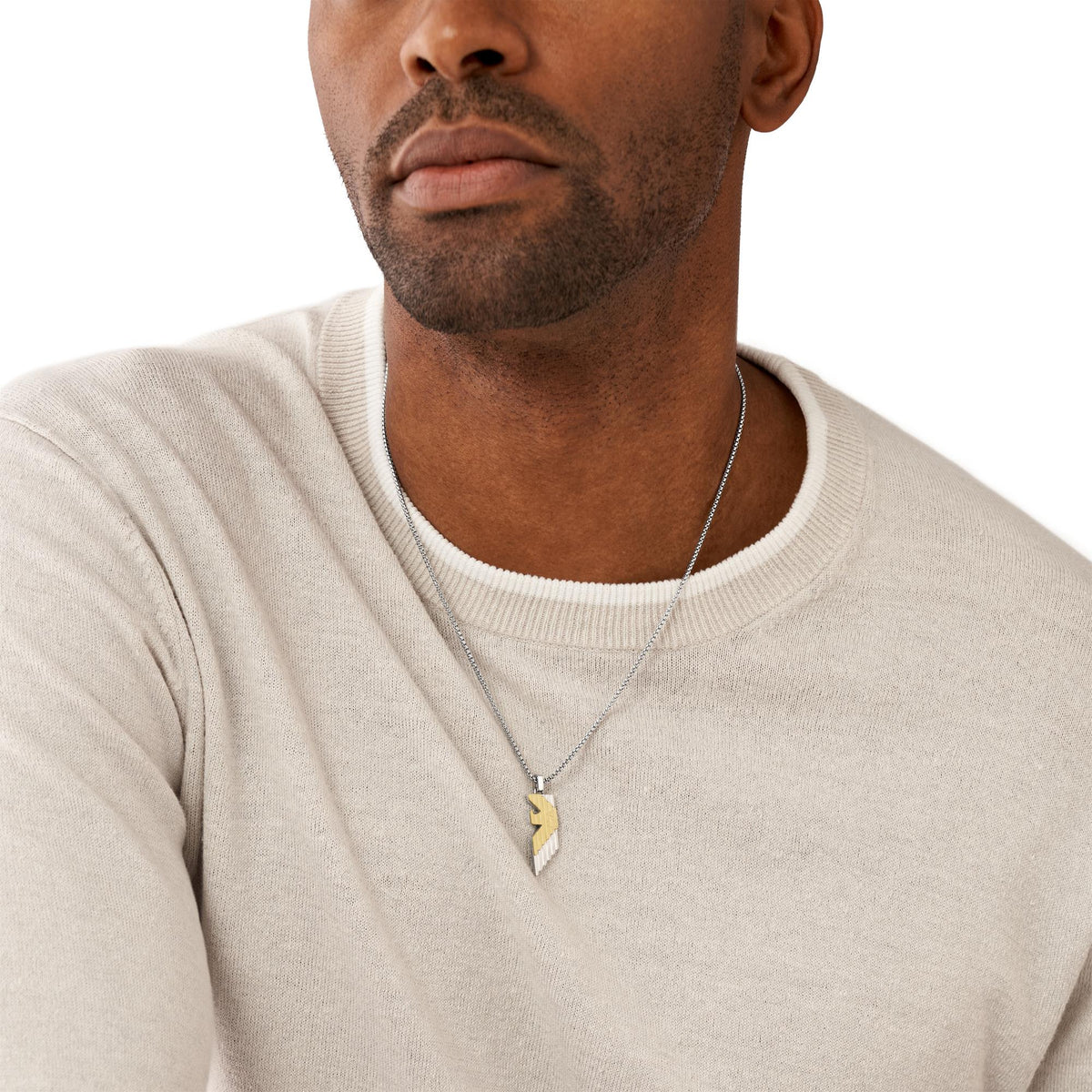 Men's pendant necklace on chest: silver chain with gold-and-silver lightning bolt charm