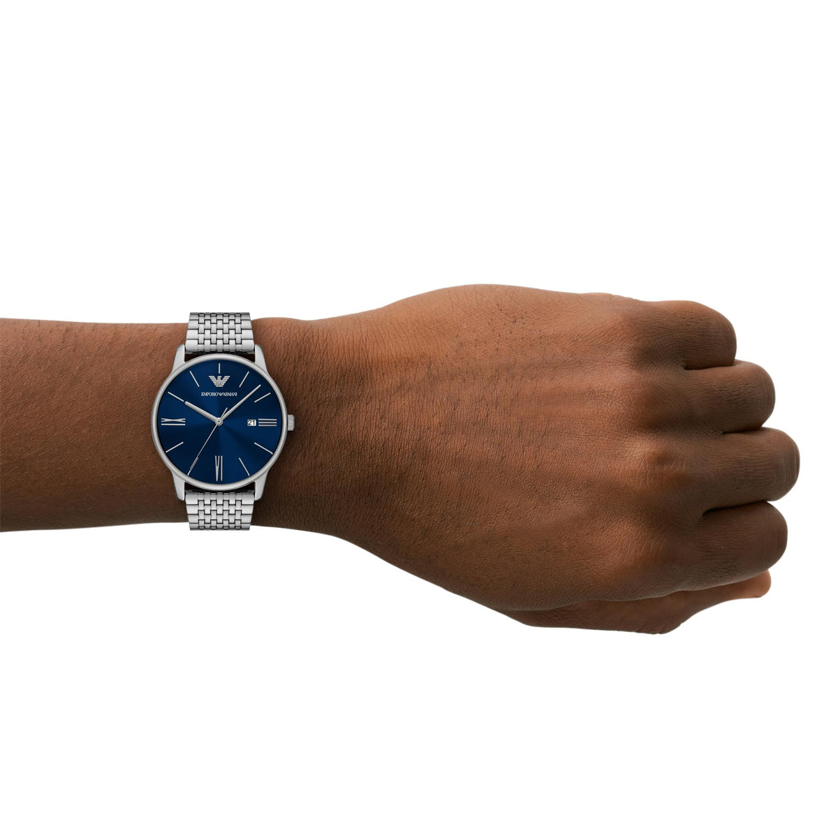Men's steel quartz watch on wrist, blue dial and linked metal bracelet