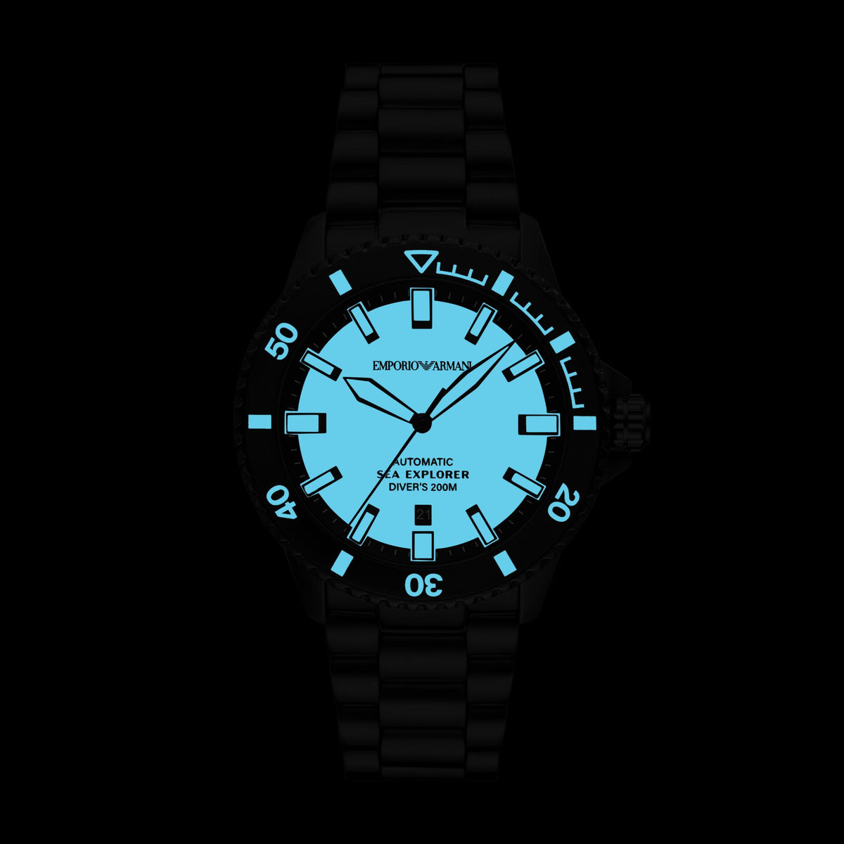 Illuminated view of the Emporio Armani Sea Explorer AR60084 displaying glowing luminescent blue dial markers and hands