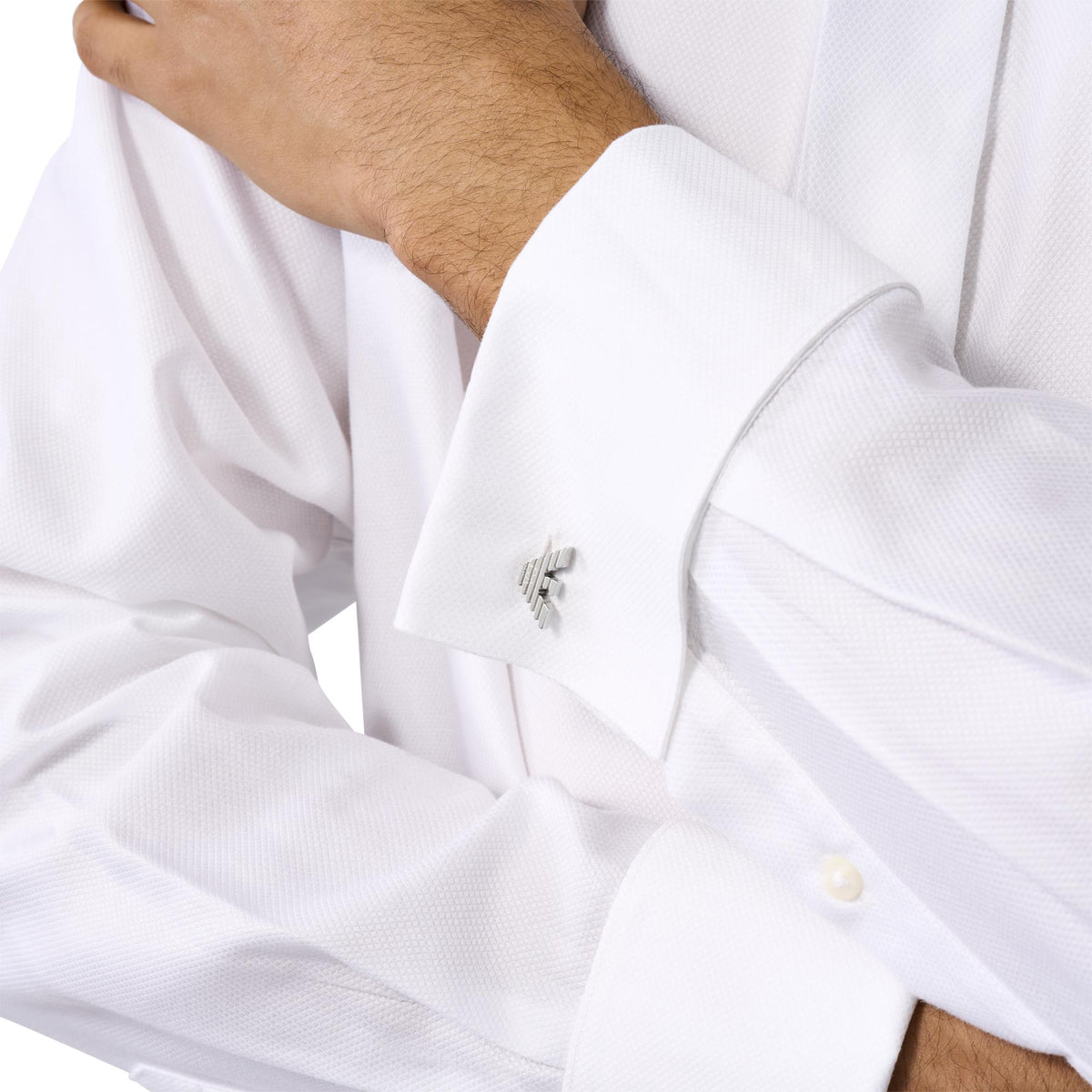 Stainless steel cuff links on a white dress shirt cuff