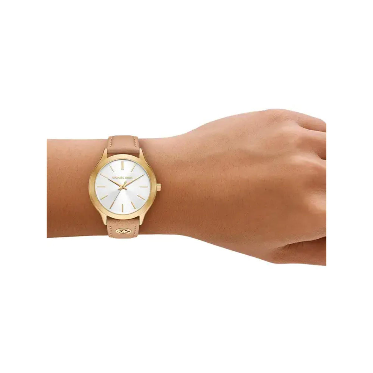 Women's Michael Kors watch on wrist with nude leather strap and white dial
