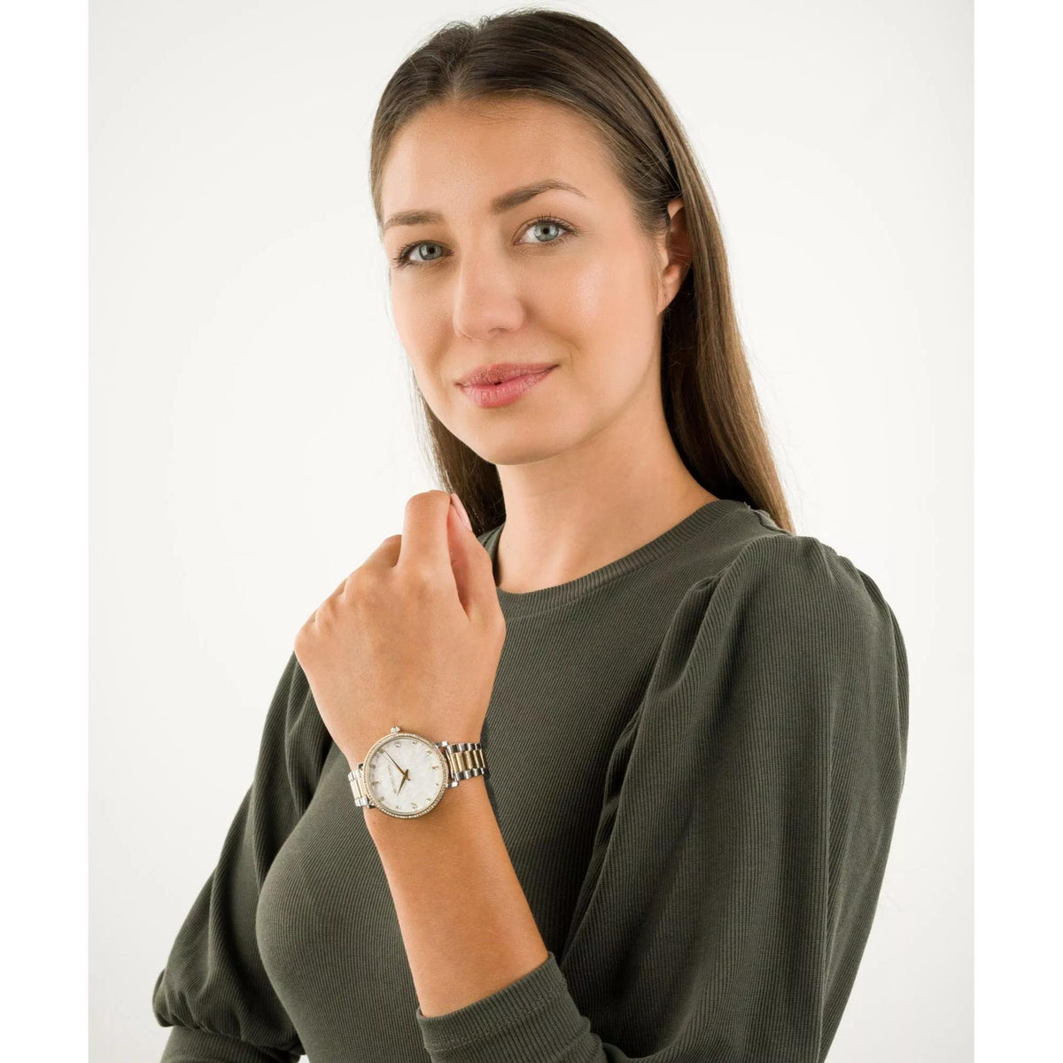 Two-tone stainless steel watch on wrist with white dial and crystal bezel.
