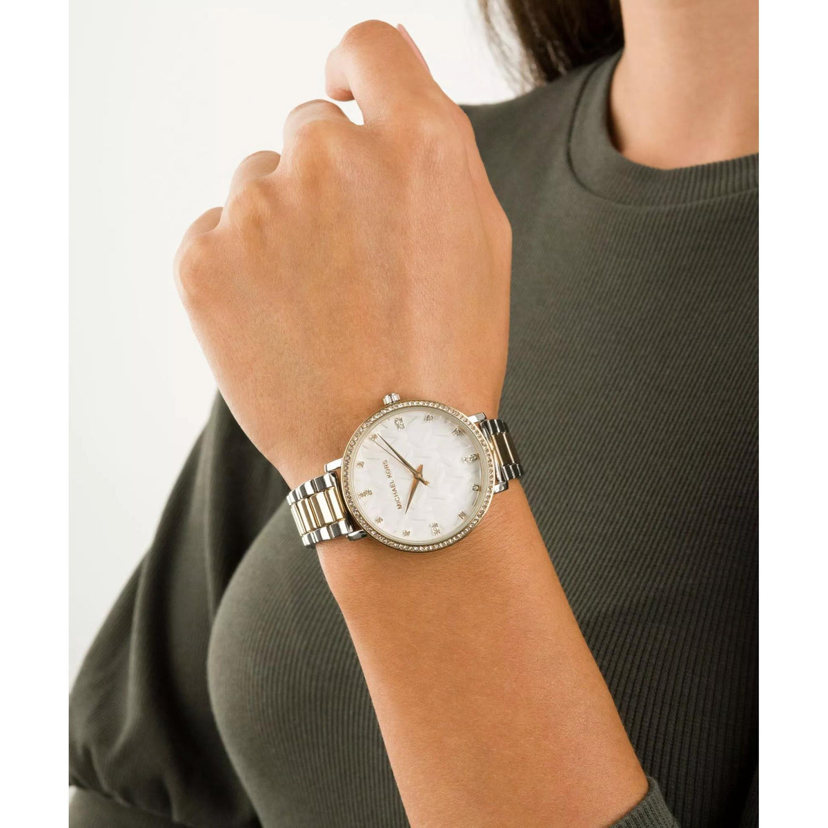 Two-tone stainless steel wrist watch with white dial and gold-toned accents, crystal bezel.