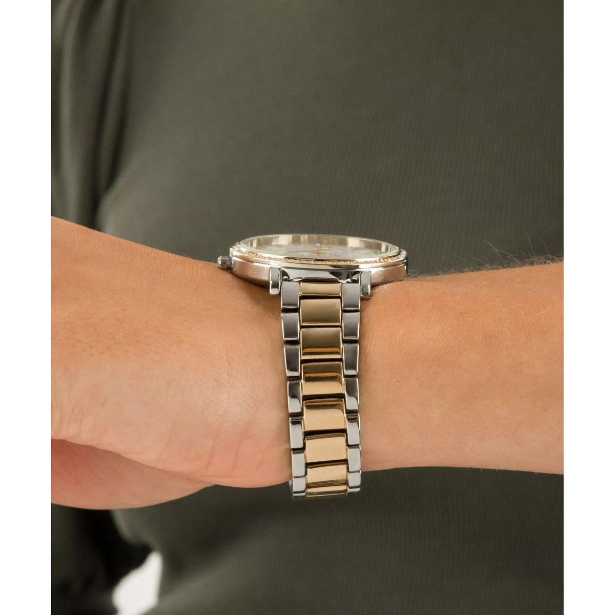 Two-tone stainless steel bracelet and watch case on wrist with reflective links.