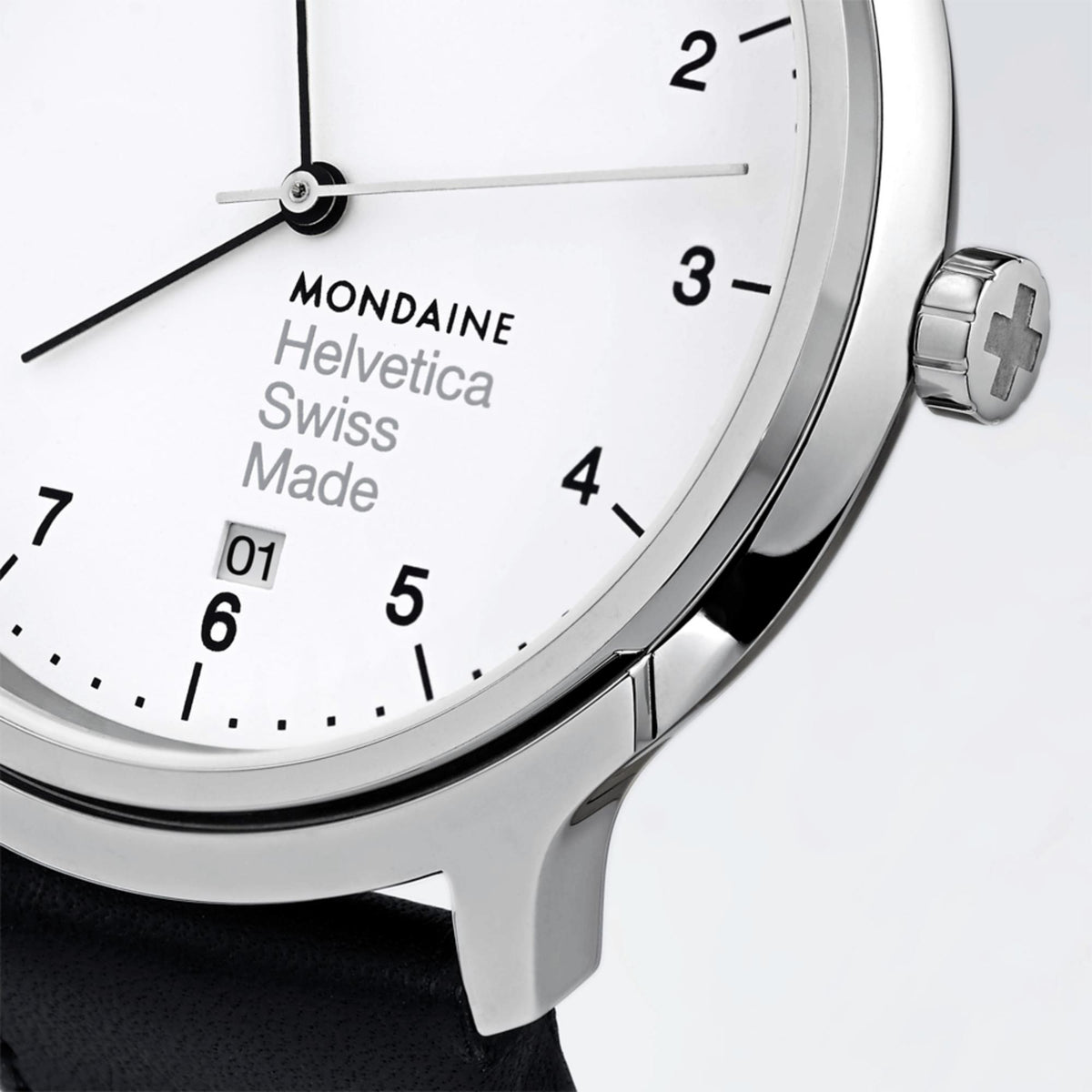 Men's watch white dial close-up with black hands and silver crown, black strap