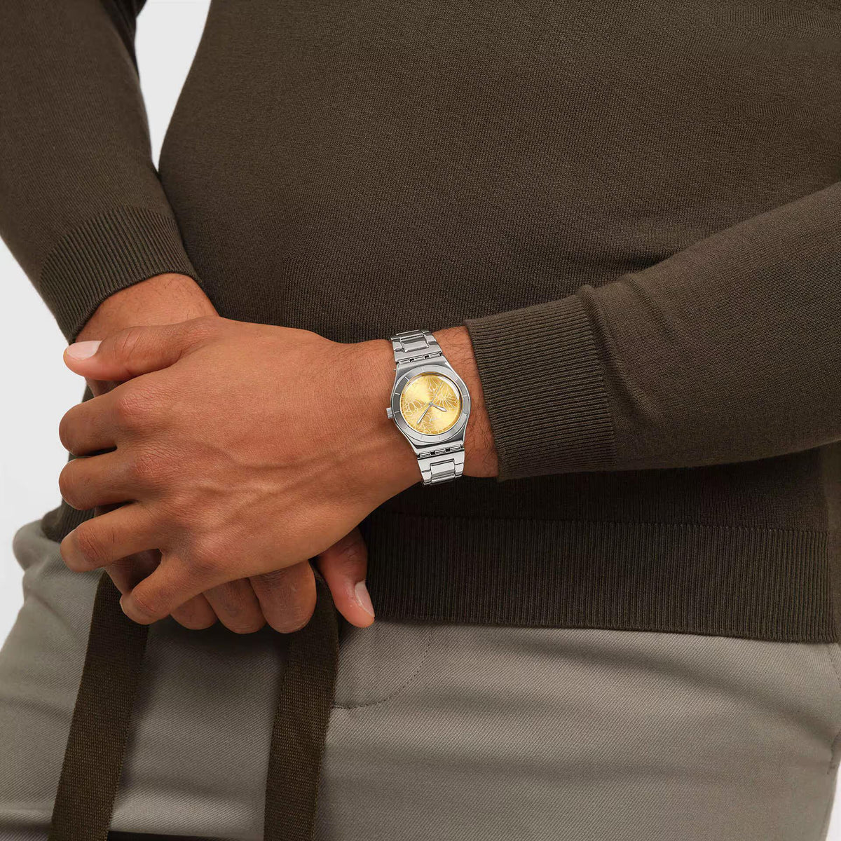 Steel strap watch with yellow dial on wrist, silver bracelet visible