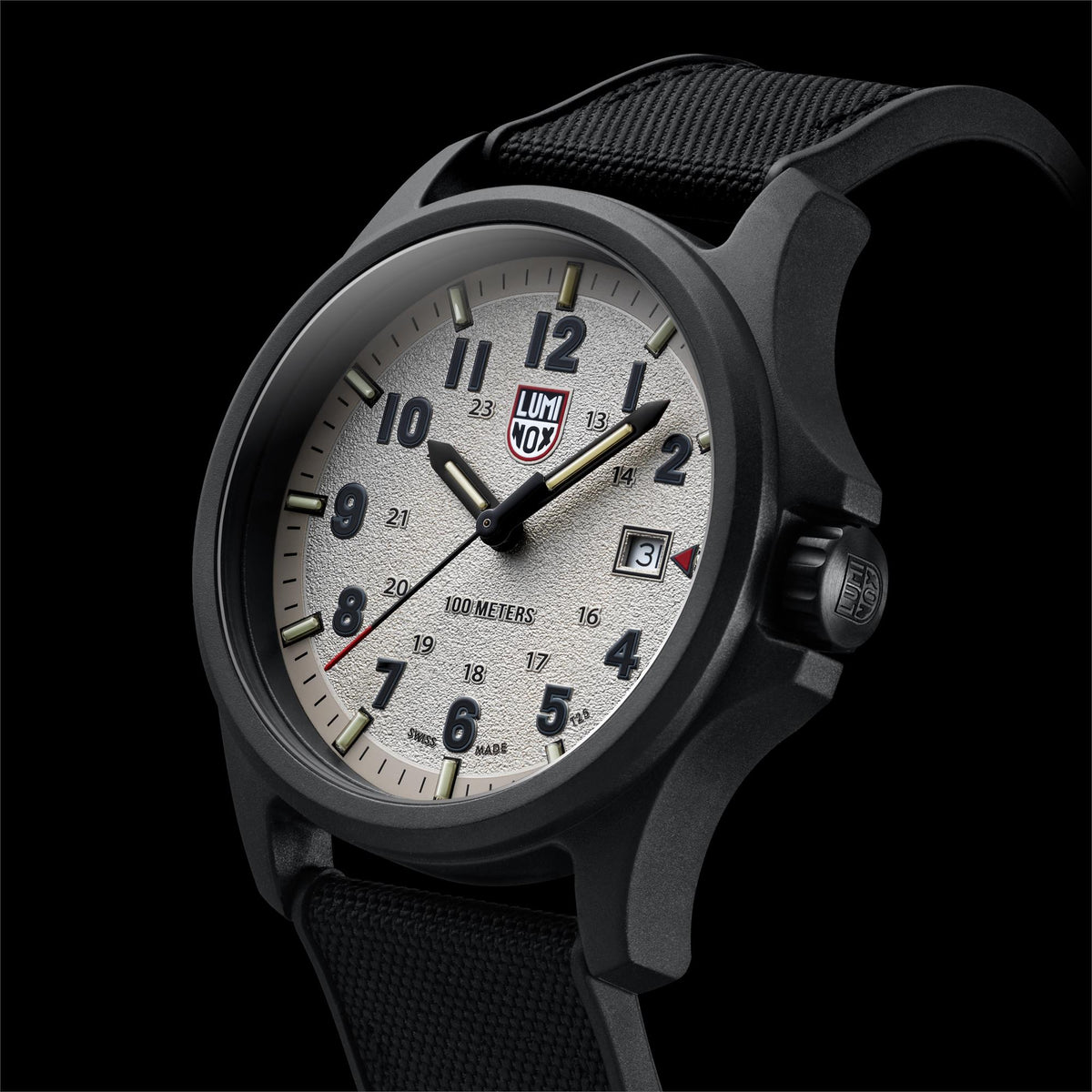 Black field watch with grey dial, luminous indices, textured fabric strap, and crown