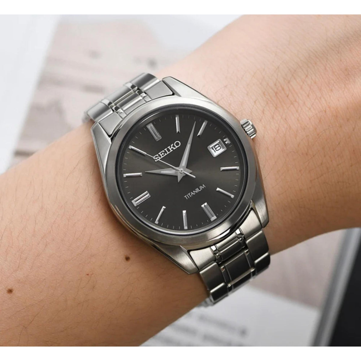 Seiko SUR375P1 on a wrist with a blurred background