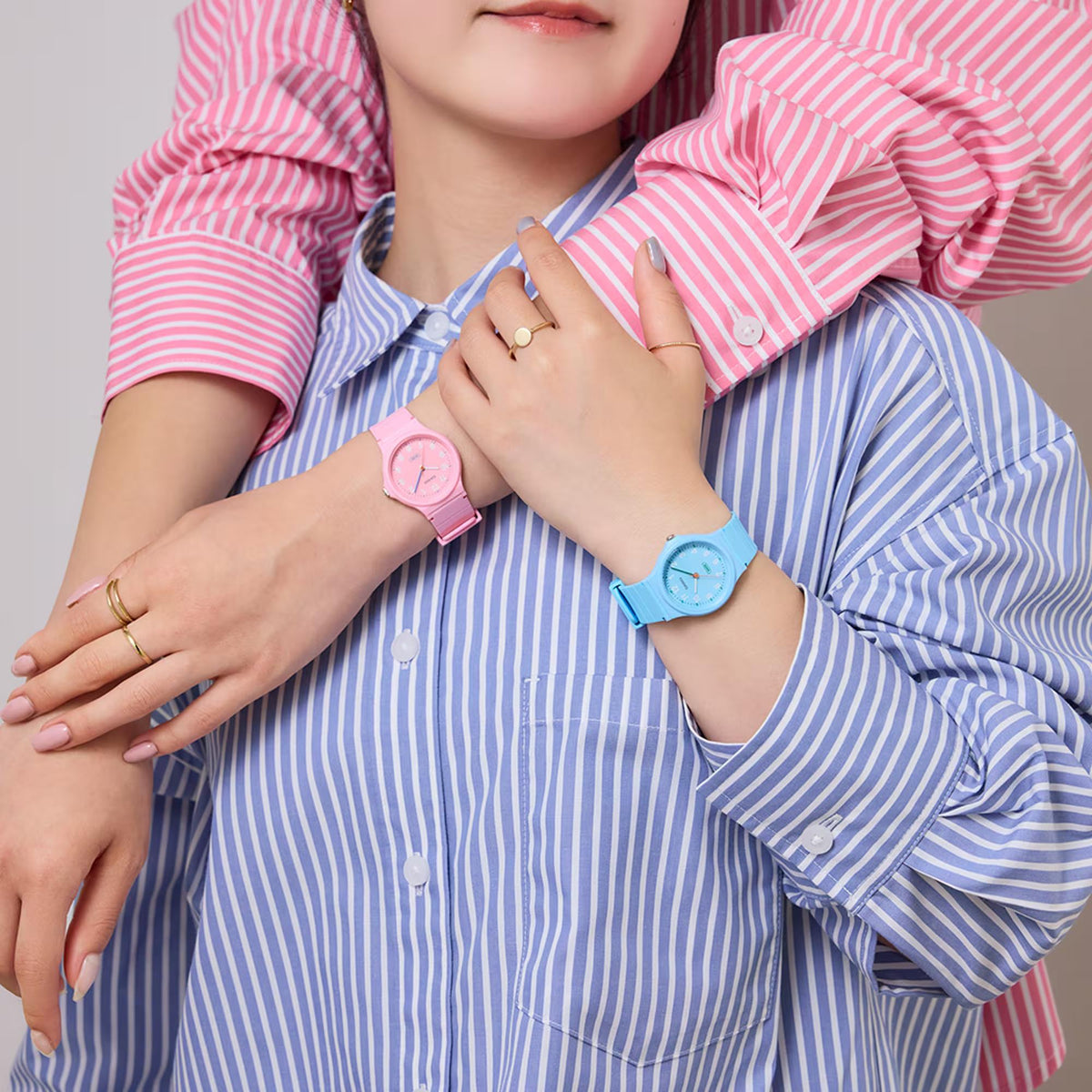 Light blue resin strap wristwatch on hand with blue dial and green second hand
