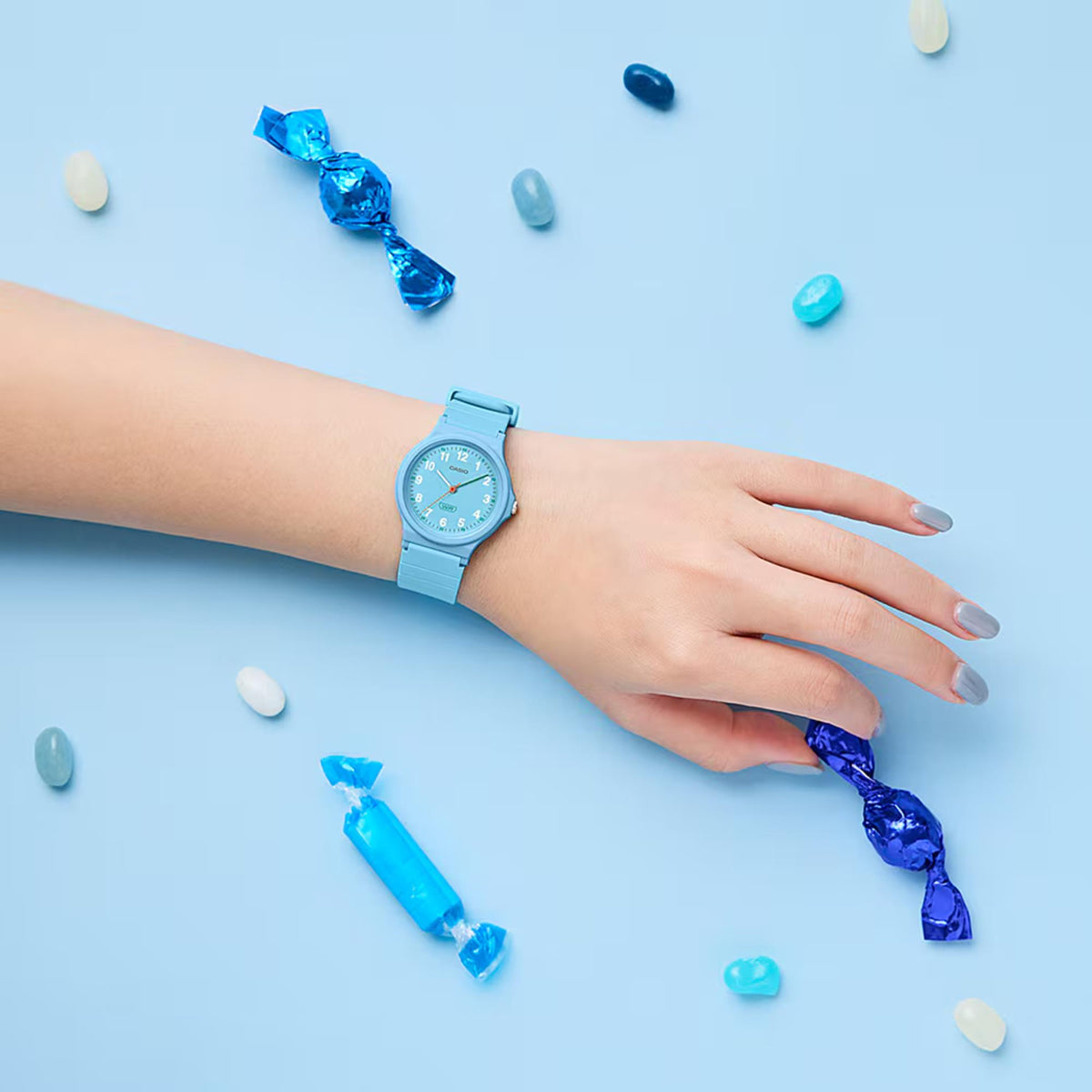 Light blue resin strap wristwatch on hand with round blue dial