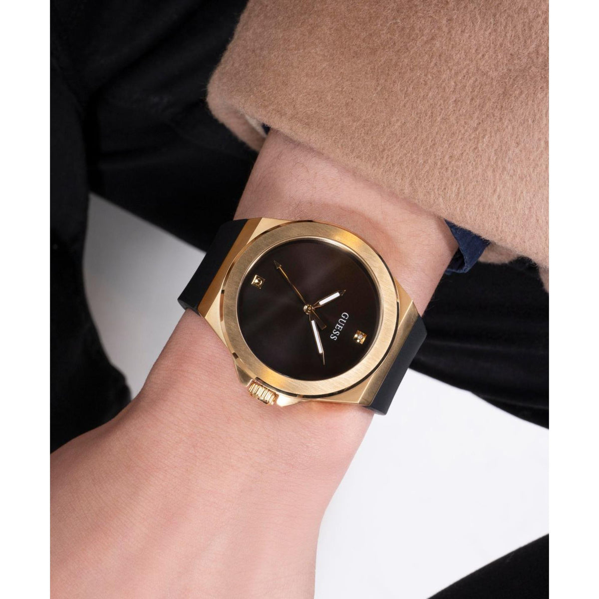 Men's analog watch on wrist, gold case and black dial with slim hands