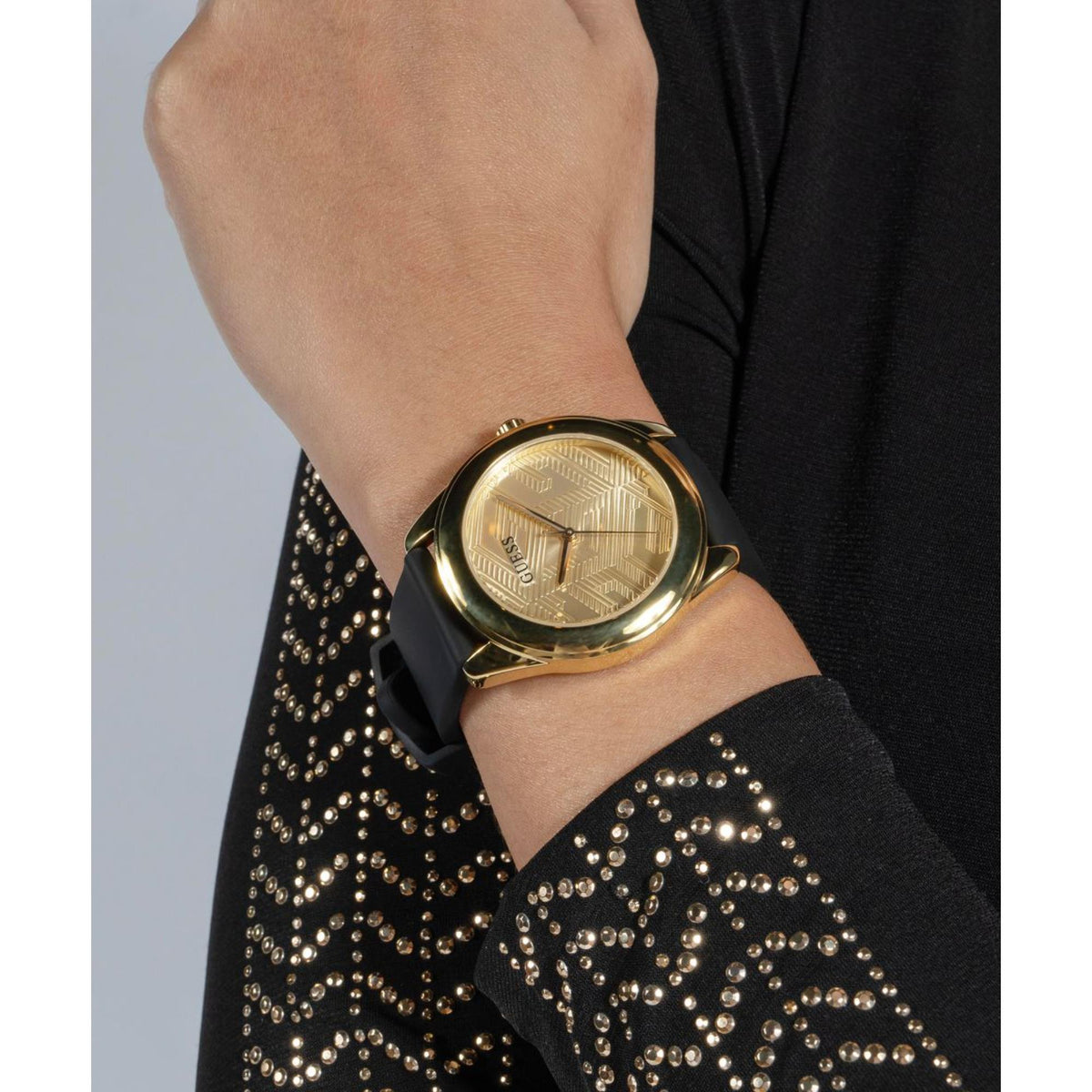 Women's wristwatch with gold-tone case, textured gold dial, and black silicone band