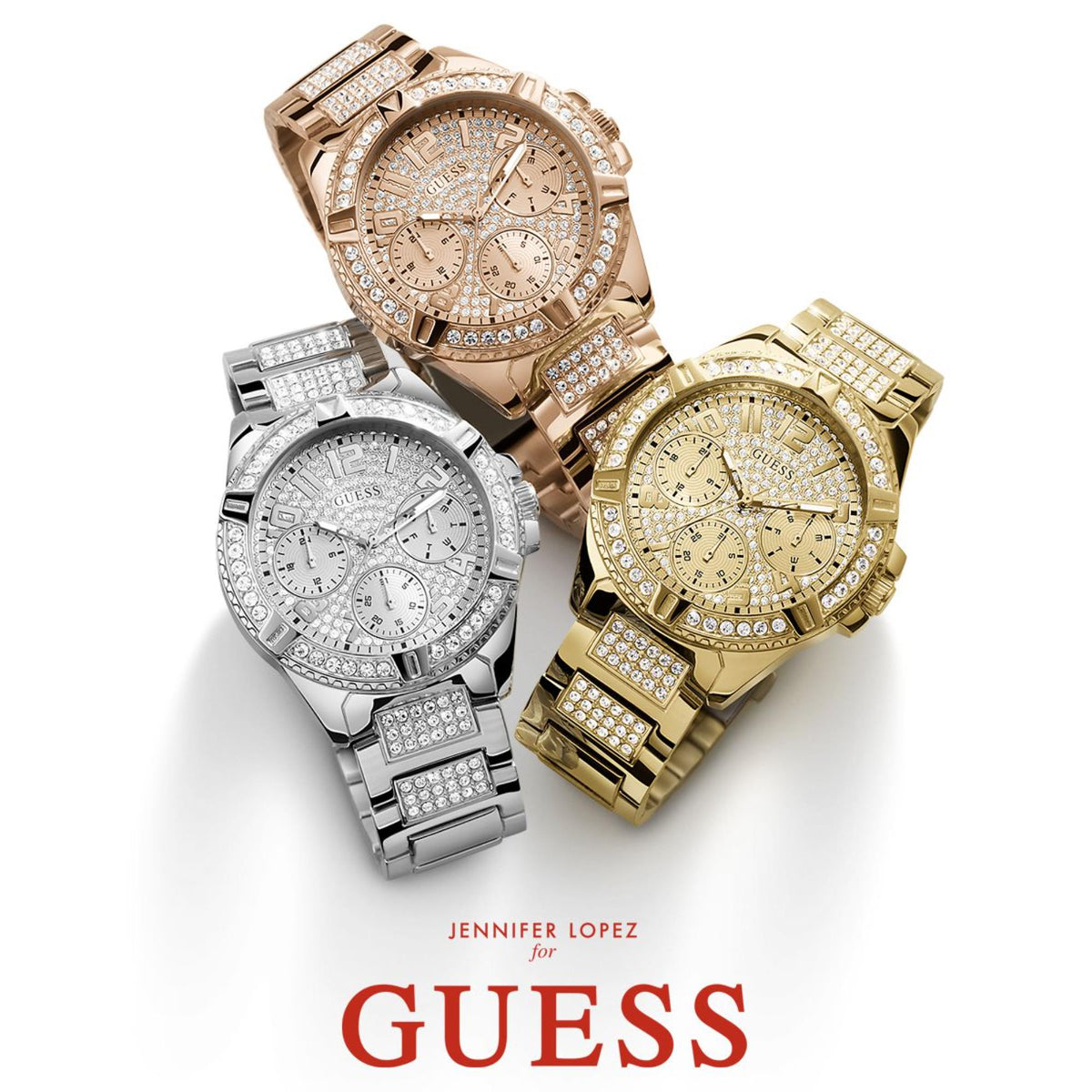 Jeweled chronograph-style watches on display: rose, gold, and silver with subdials