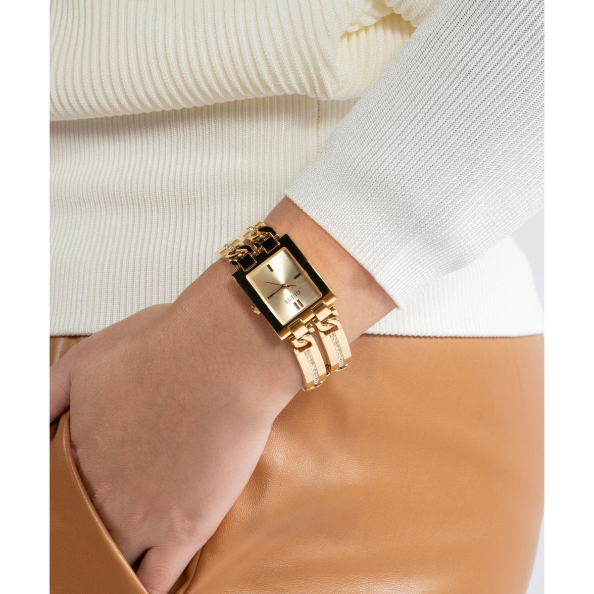 Women’s gold-tone watch on wrist with champagne dial and crystal-accent bracelet links