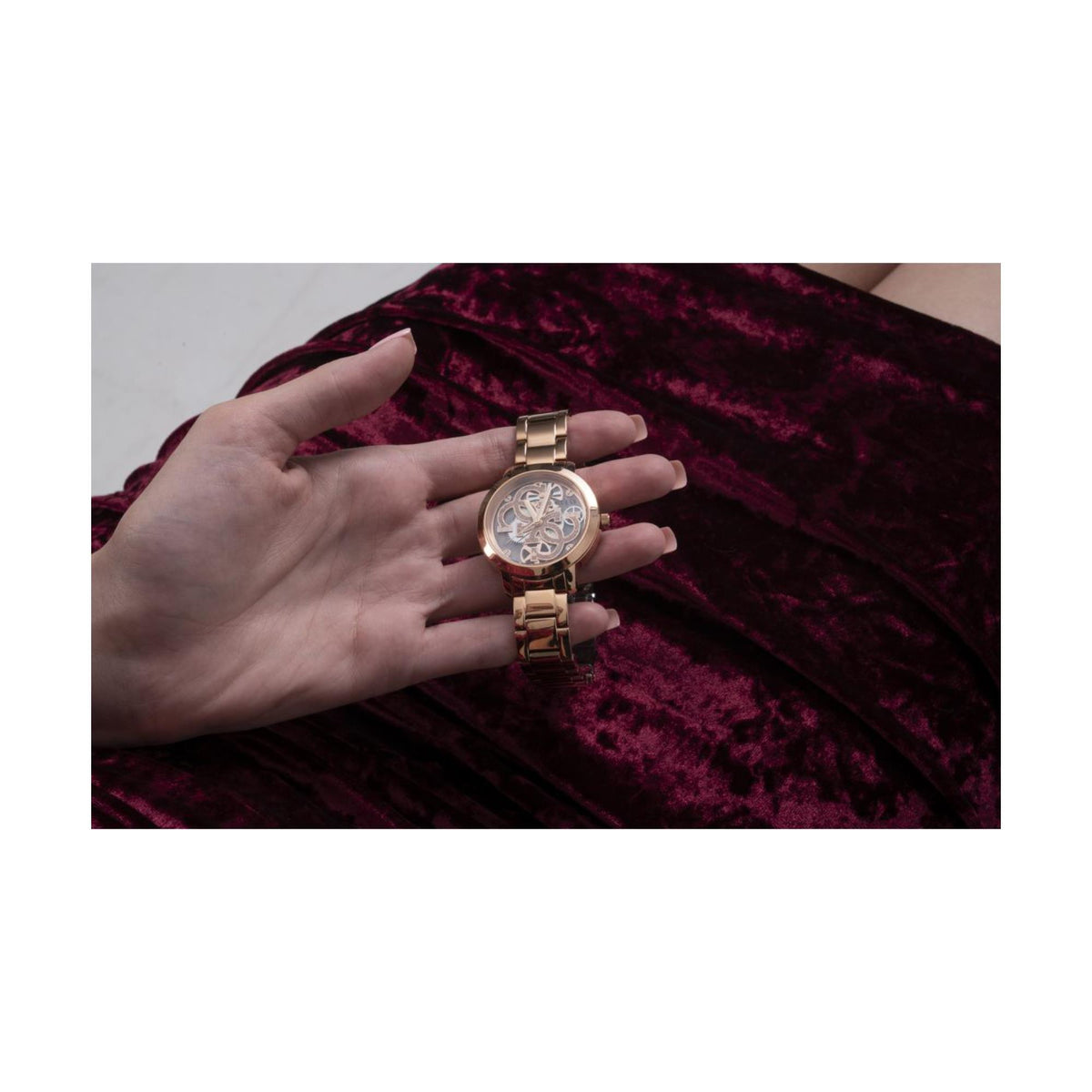 Women’s rose gold skeleton watch with stainless steel bracelet on wrist