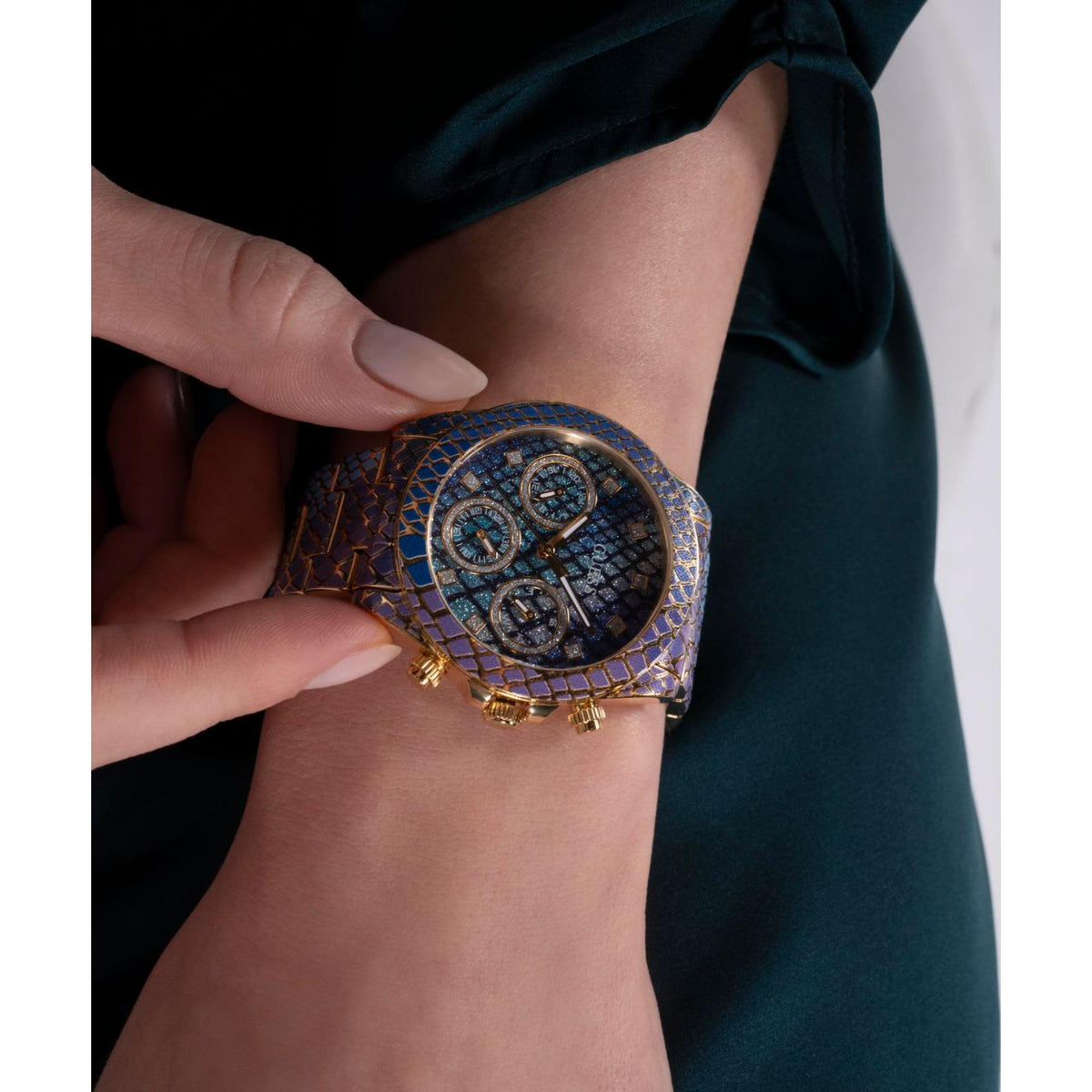 Women's animal-print watch on wrist with round blue multi-dial face and gold-tone accents