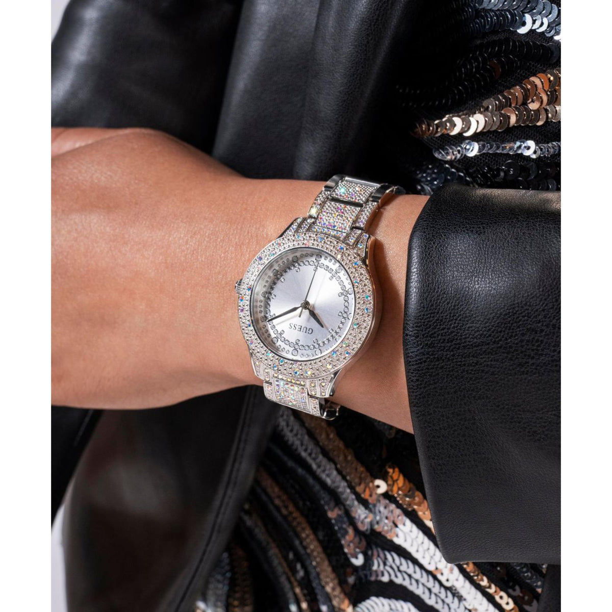 Silver crystal women's wristwatch with round dial on wrist
