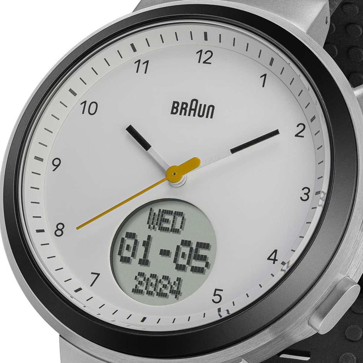 Braun Step watch close-up of white dial, black markers, yellow hands, digital date display