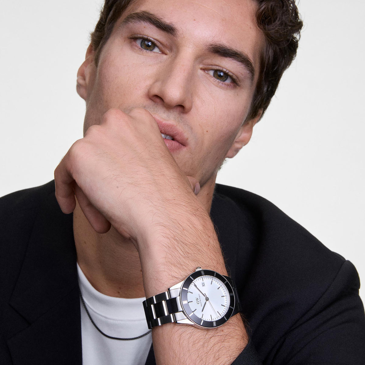 Steel quartz watch on wrist with white dial and black bezel