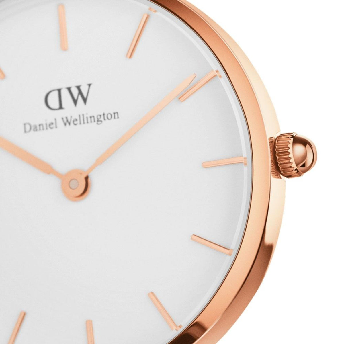 Daniel Wellington watch crown and dial close-up with rose-gold accents on white face