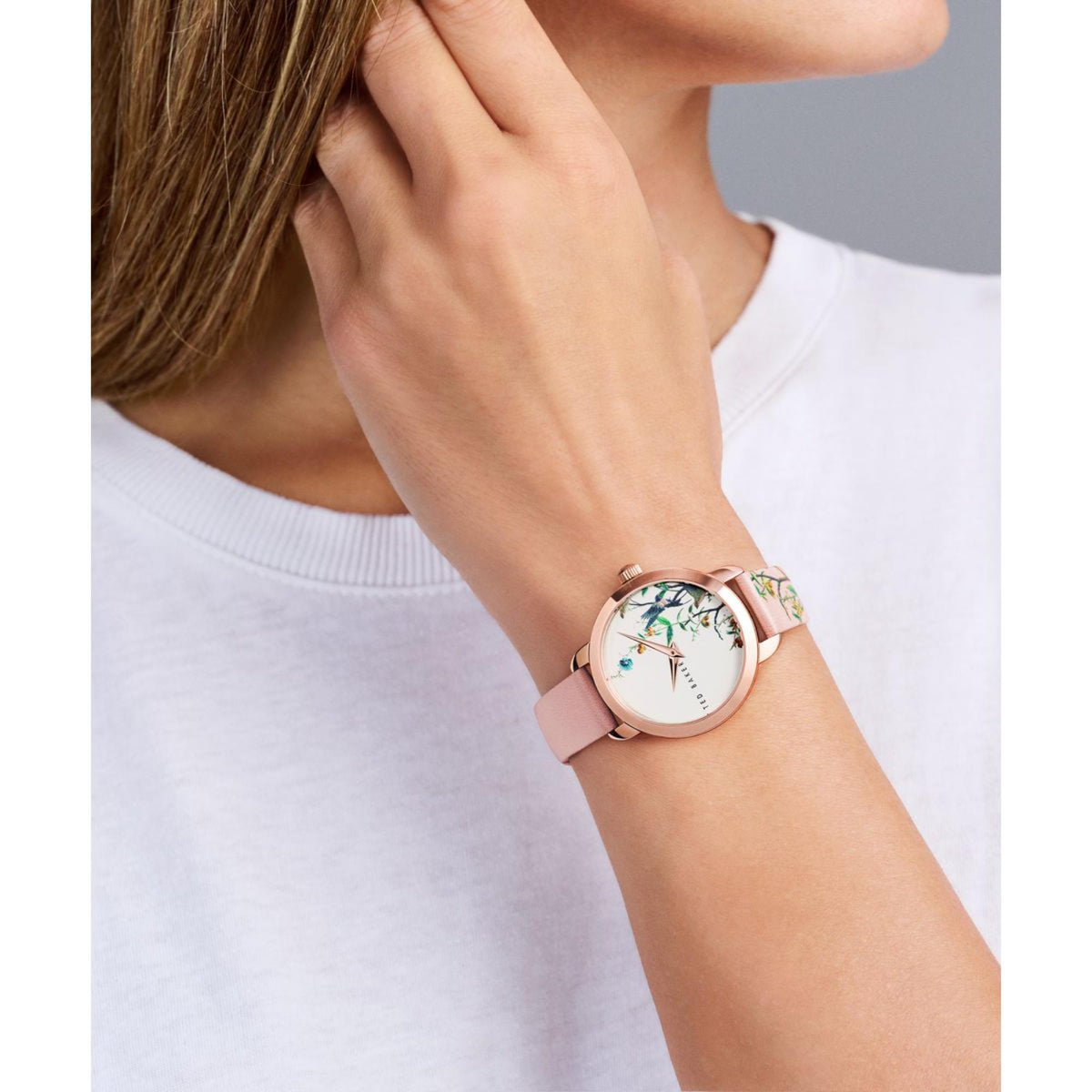 Women’s light pink leather strap watch with rose-gold case and floral bird dial