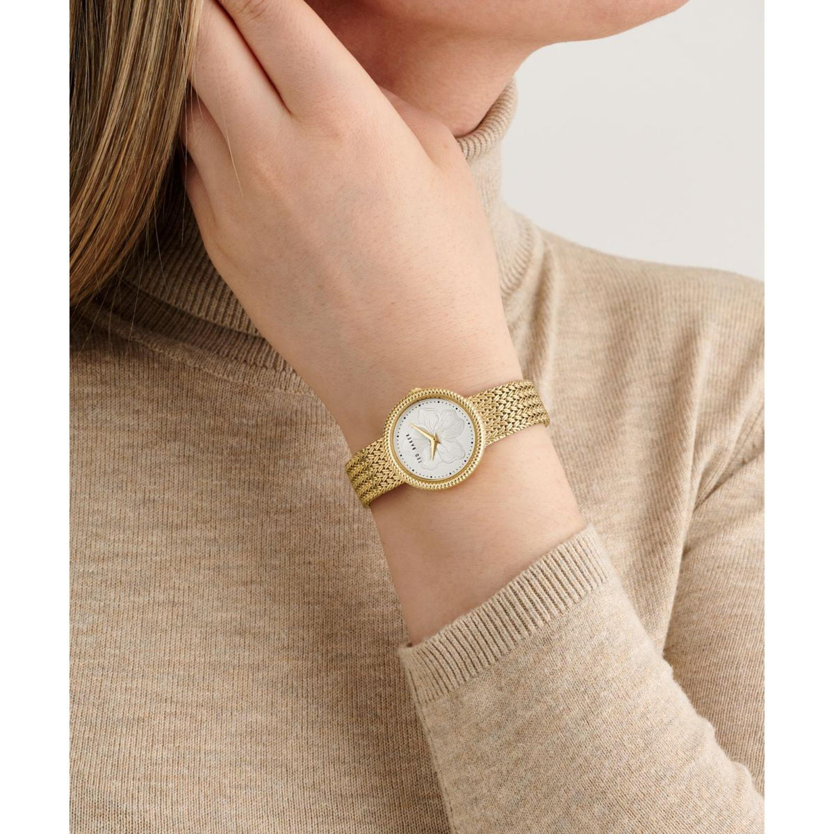 Ted Baker Emily ladies watch on wrist, gold-tone mesh strap with white floral dial