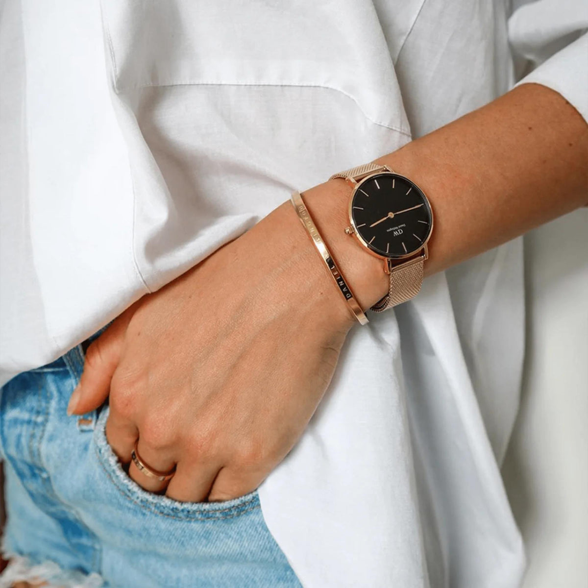 Ladies quartz watch on wrist, black dial with gold-tone mesh strap