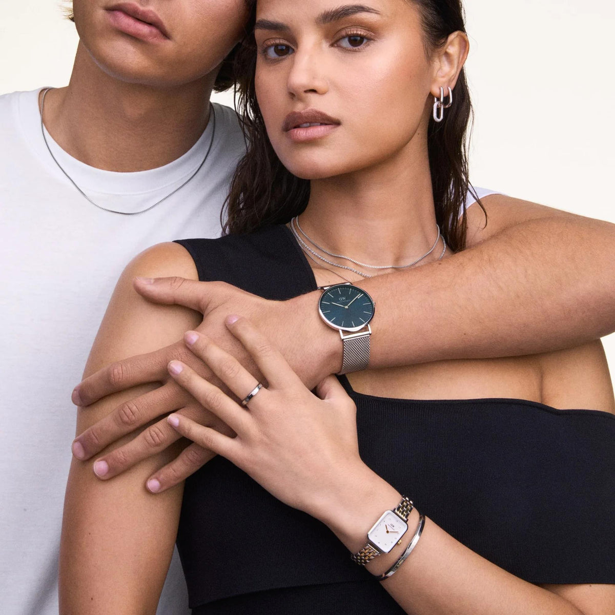 Two-tone steel watch with white face and gold markers worn on wrist