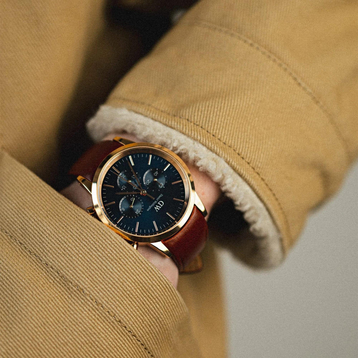 Daniel Wellington chronograph watch on wrist, blue dial, brown leather strap
