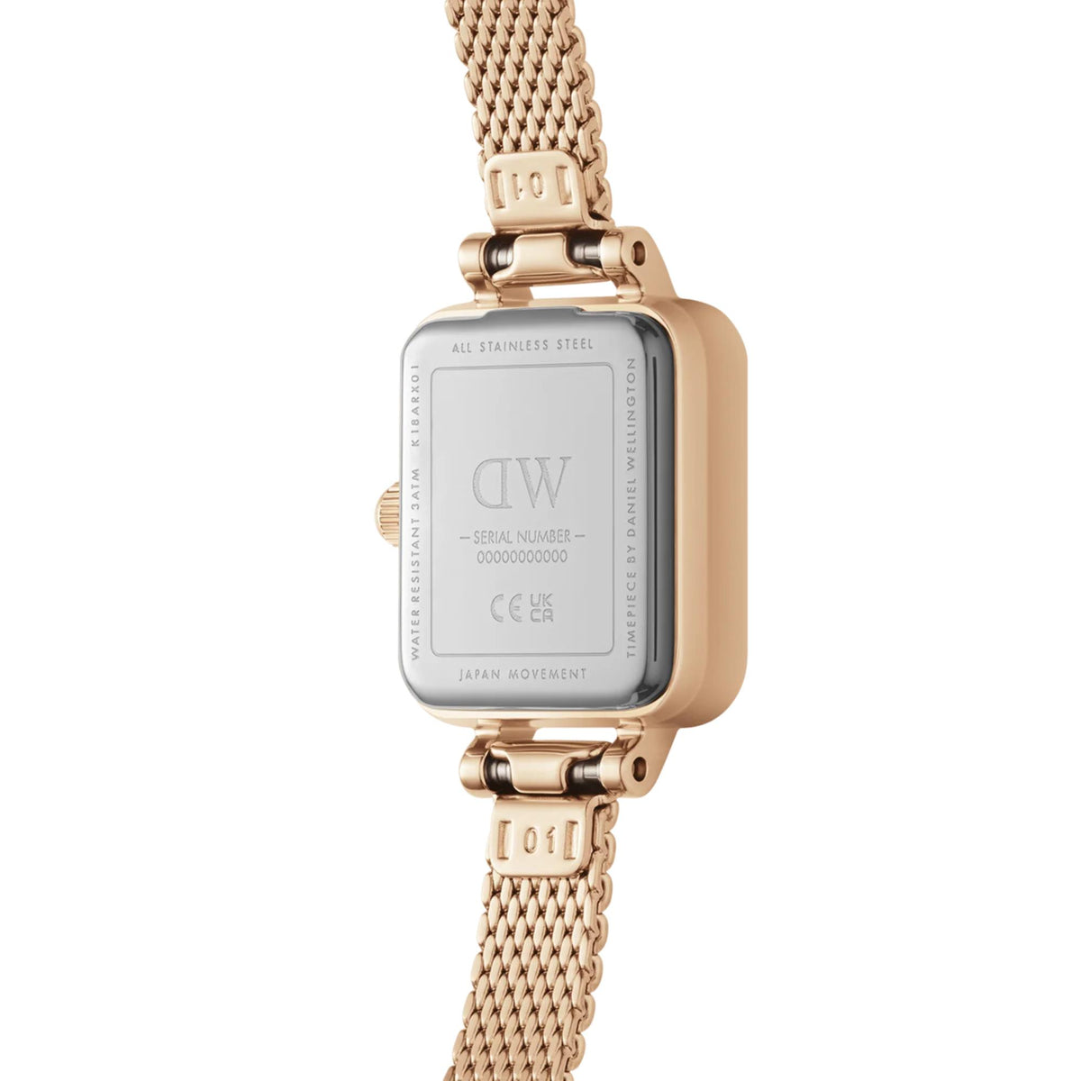 Back view of rose-gold tone square watch with steel case and mesh bracelet