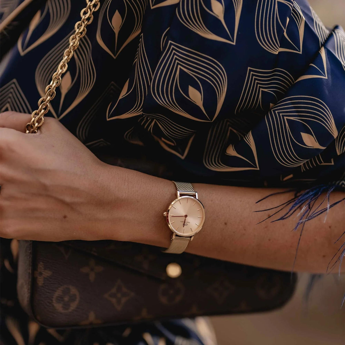 Petite rose gold dial quartz watch with steel mesh bracelet on wrist