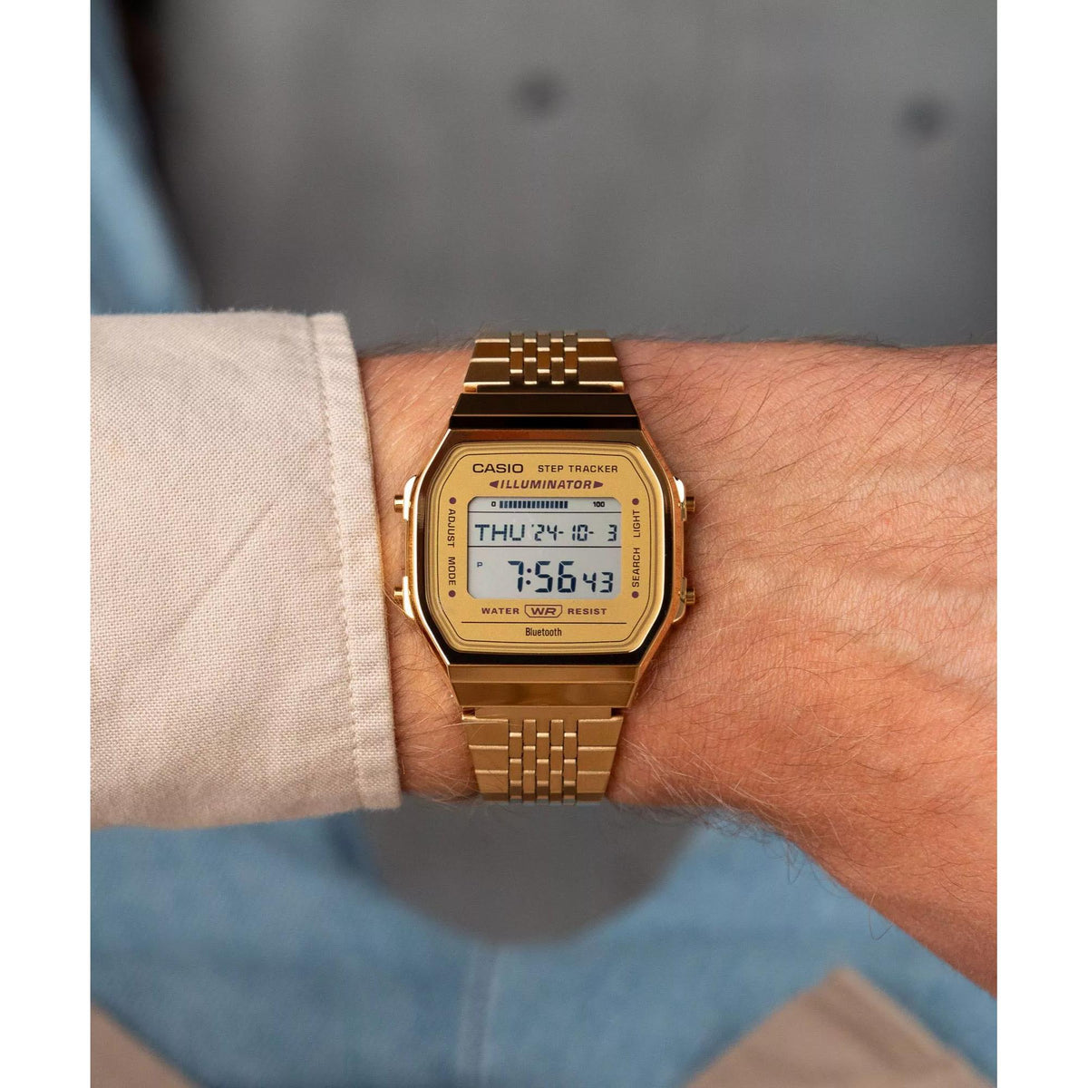 Close-up wrist shot displaying the rectangular gold-colored bezel and digital display of the Casio Vintage Digital ABL-100WEG-9AEF timepiece
