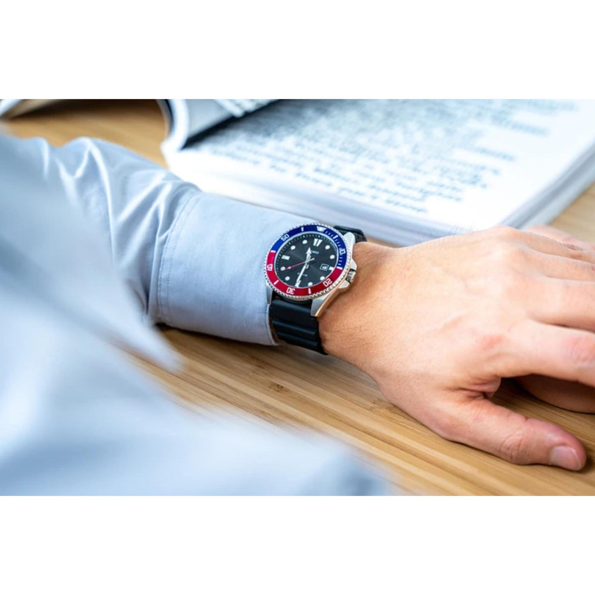 Close-up of the Casio Marlin MDV-107-1A3VEF black dial resin strap watch worn on a wrist resting on a desk