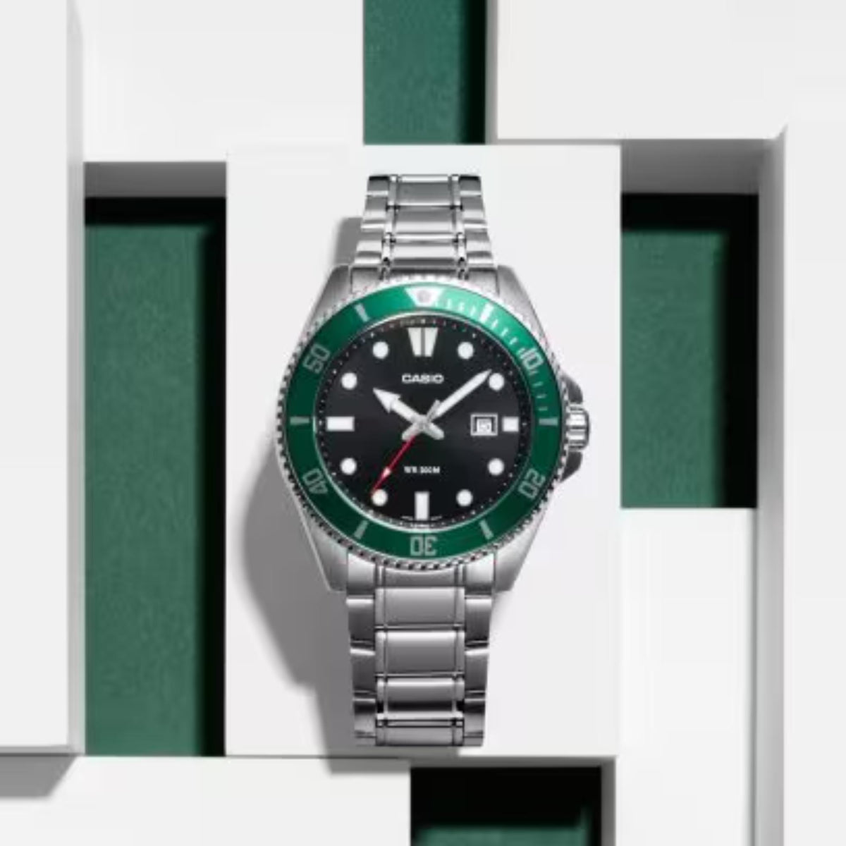 Casio men's stainless steel watch with green bezel and black dial, metal bracelet