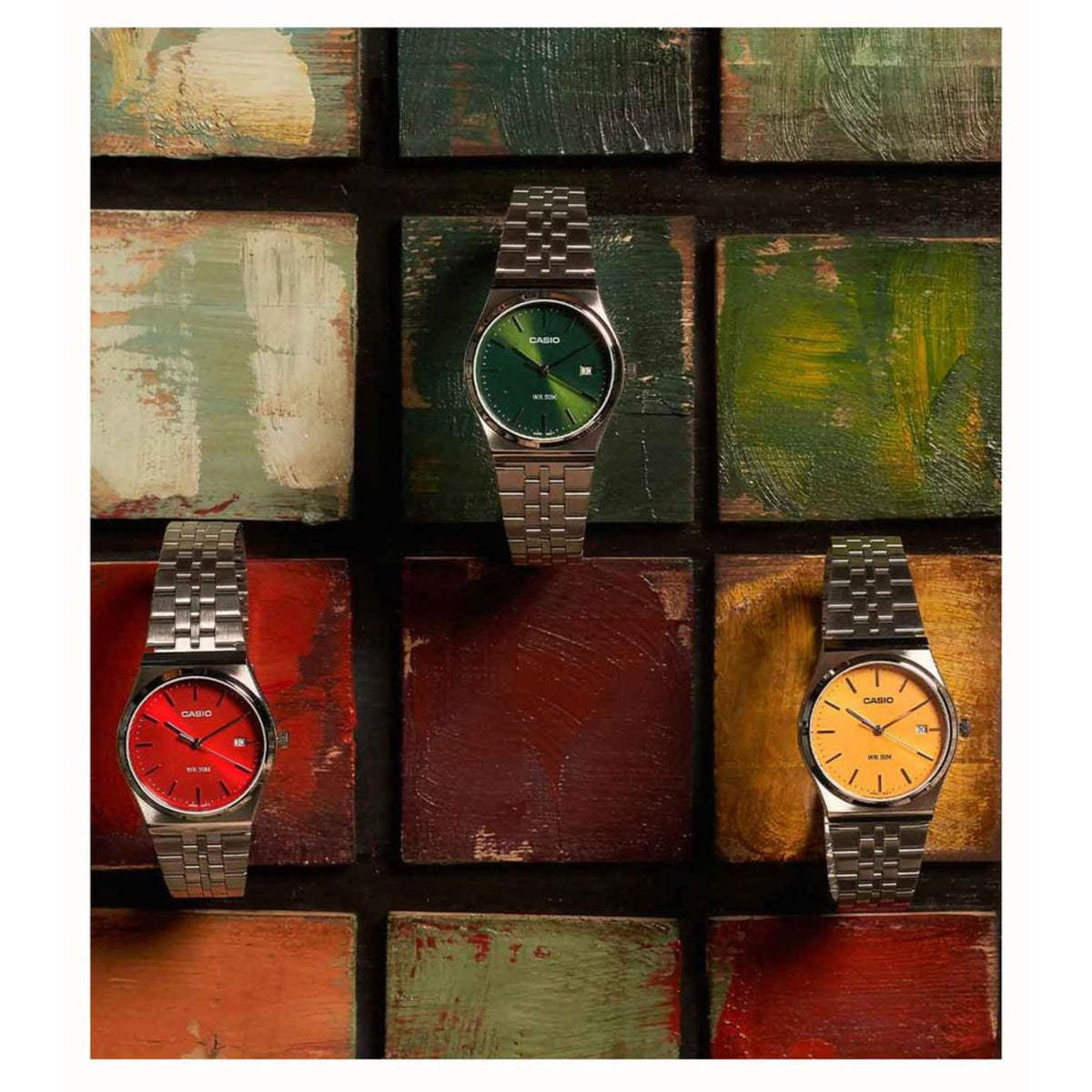 Yellow-dial men's steel strap watch with silver case, shown among other color dials
