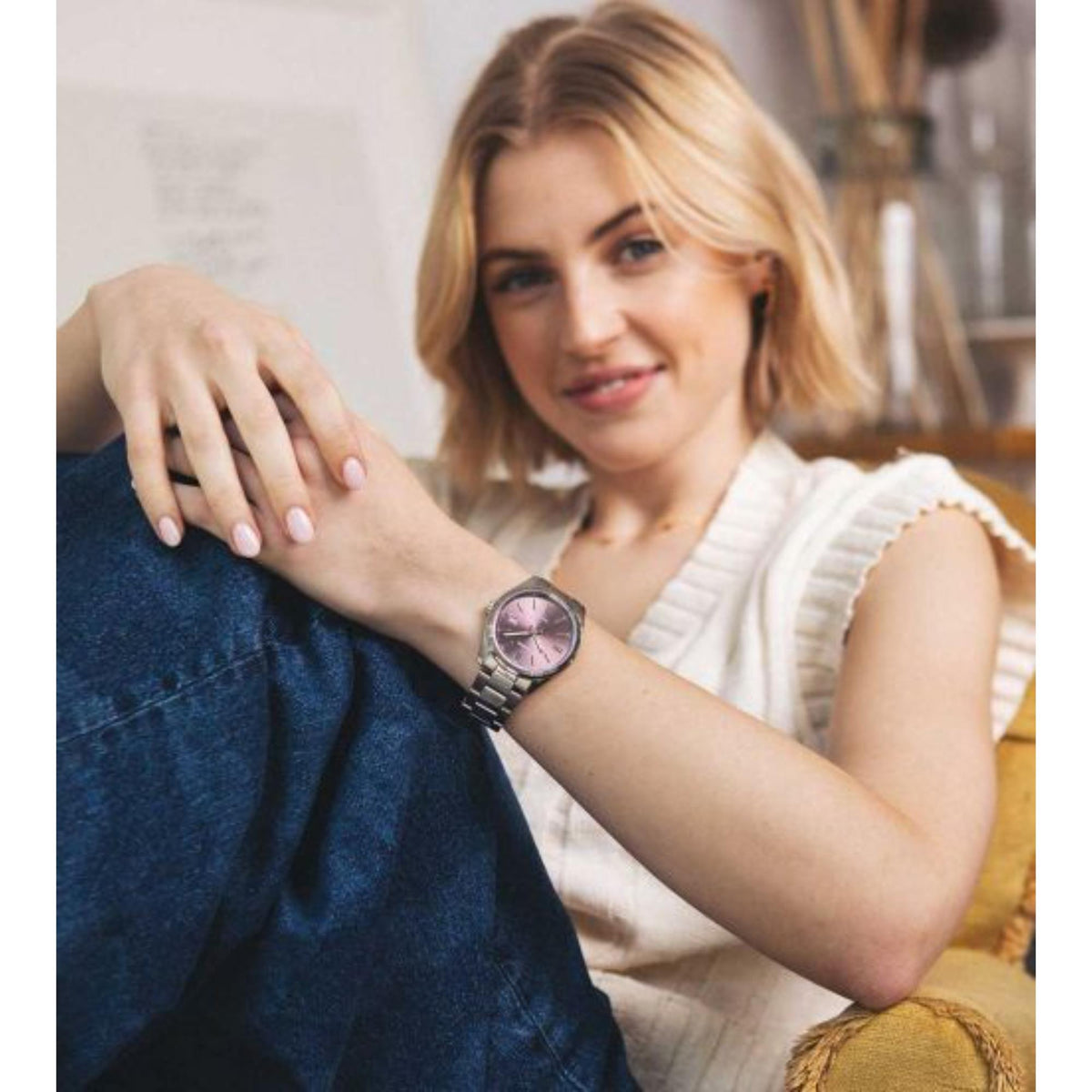 Purple dial stainless steel watch on wrist with metal bracelet and Casio logo
