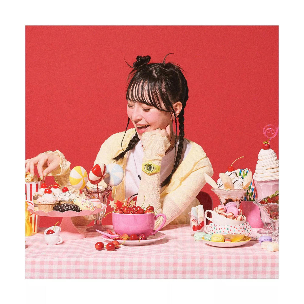 Lifestyle shot of a model wearing the Casio Baby-G BG-169CH-9ER yellow watch at a dessert-themed table