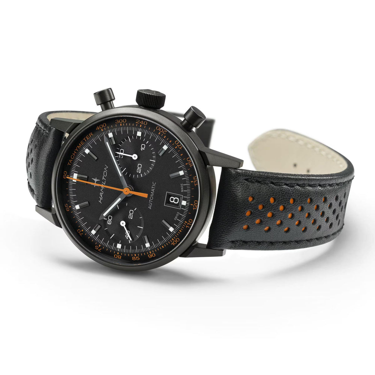 Black chronograph watch with black leather strap and orange markers, side crown details