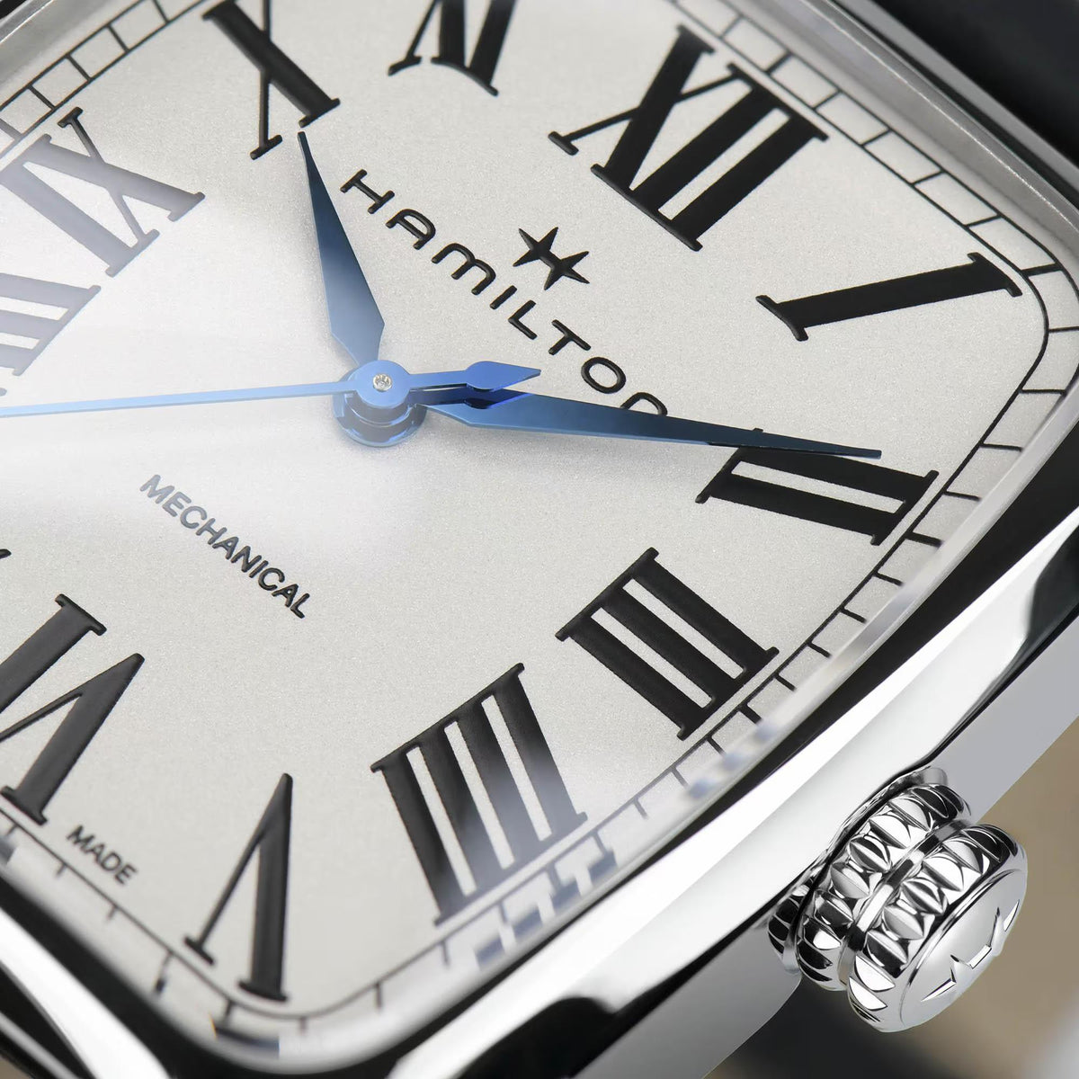Hamilton American Classic H13519711 Swiss mechanical wristwatch macro close-up featuring white dial, blue hands, and Roman numeral markers