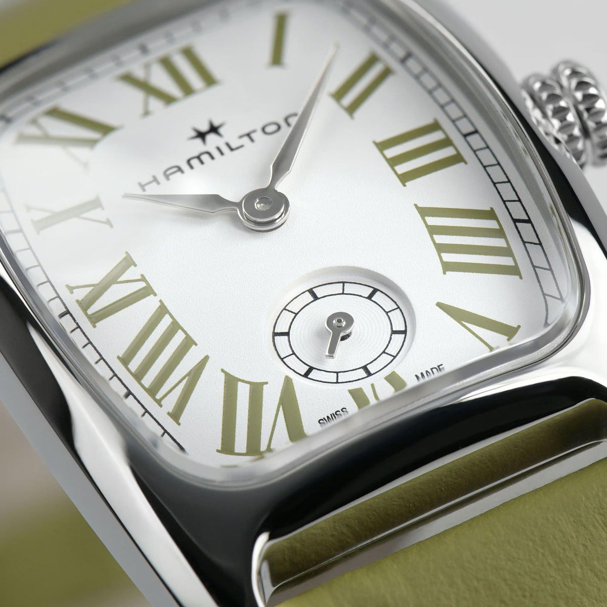 Quartz watch face with white dial, green Roman numerals, small-seconds subdial