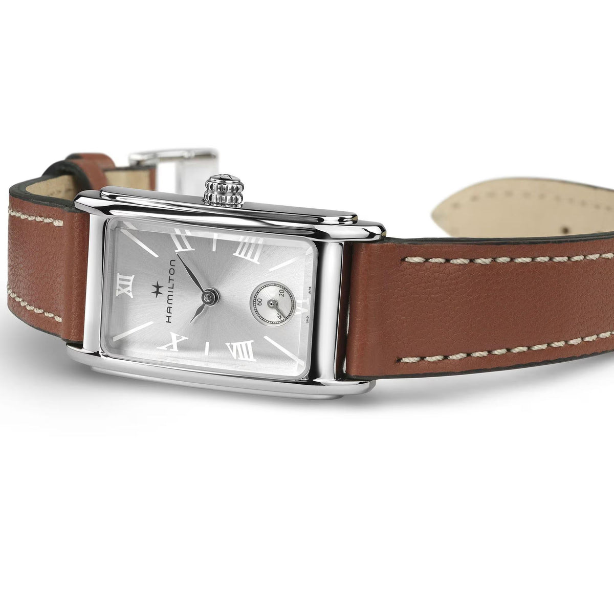 Square silver watch with brown leather strap and silver dial, side view