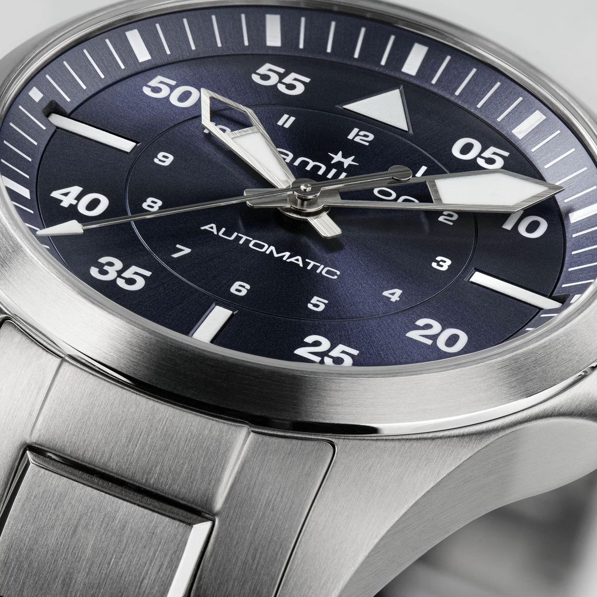 Hamilton H76215140 blue dial with large Arabic numerals and luminous hands close-up